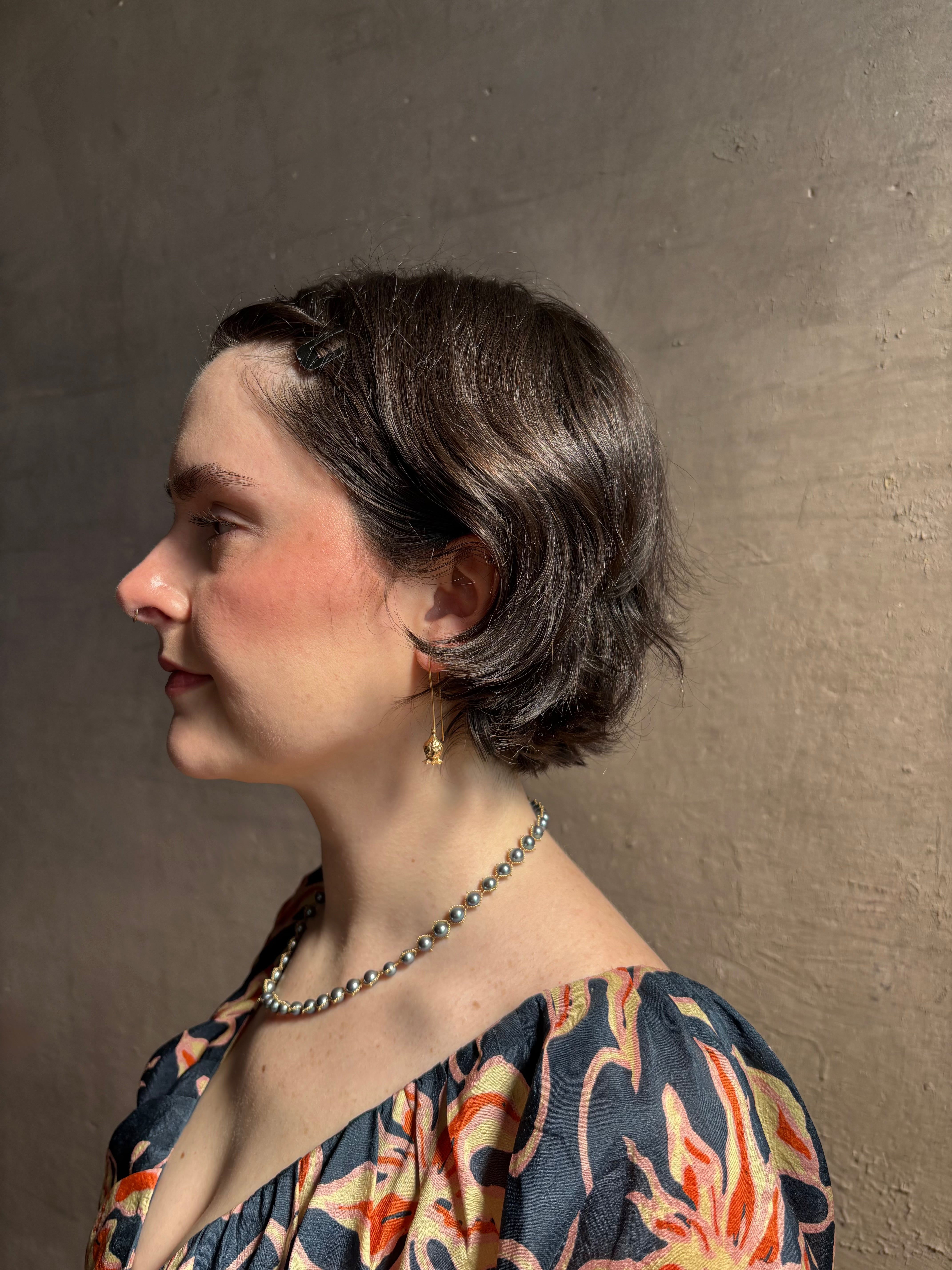 Woman wearing Poppy Pod Drop Earrings from North Carolina fine jewelry artist Amber Mahler handcrafted 18K yellow gold vermeil botanical casting