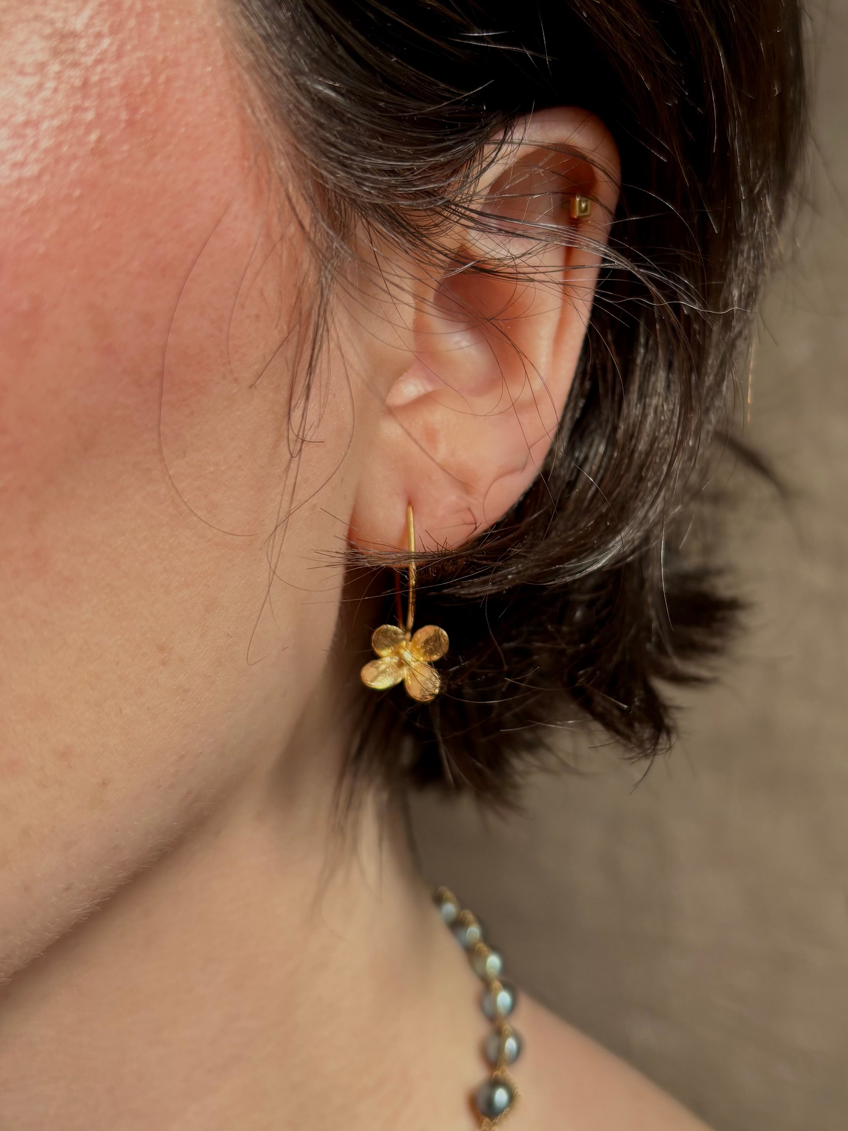 Woman wearing Purslane Rosette Hoop Earrings from North Carolina fine jewelry artist Amber Mahler  handcrafted in 18K yellow gold vermeil cast directly from the purslane rosette