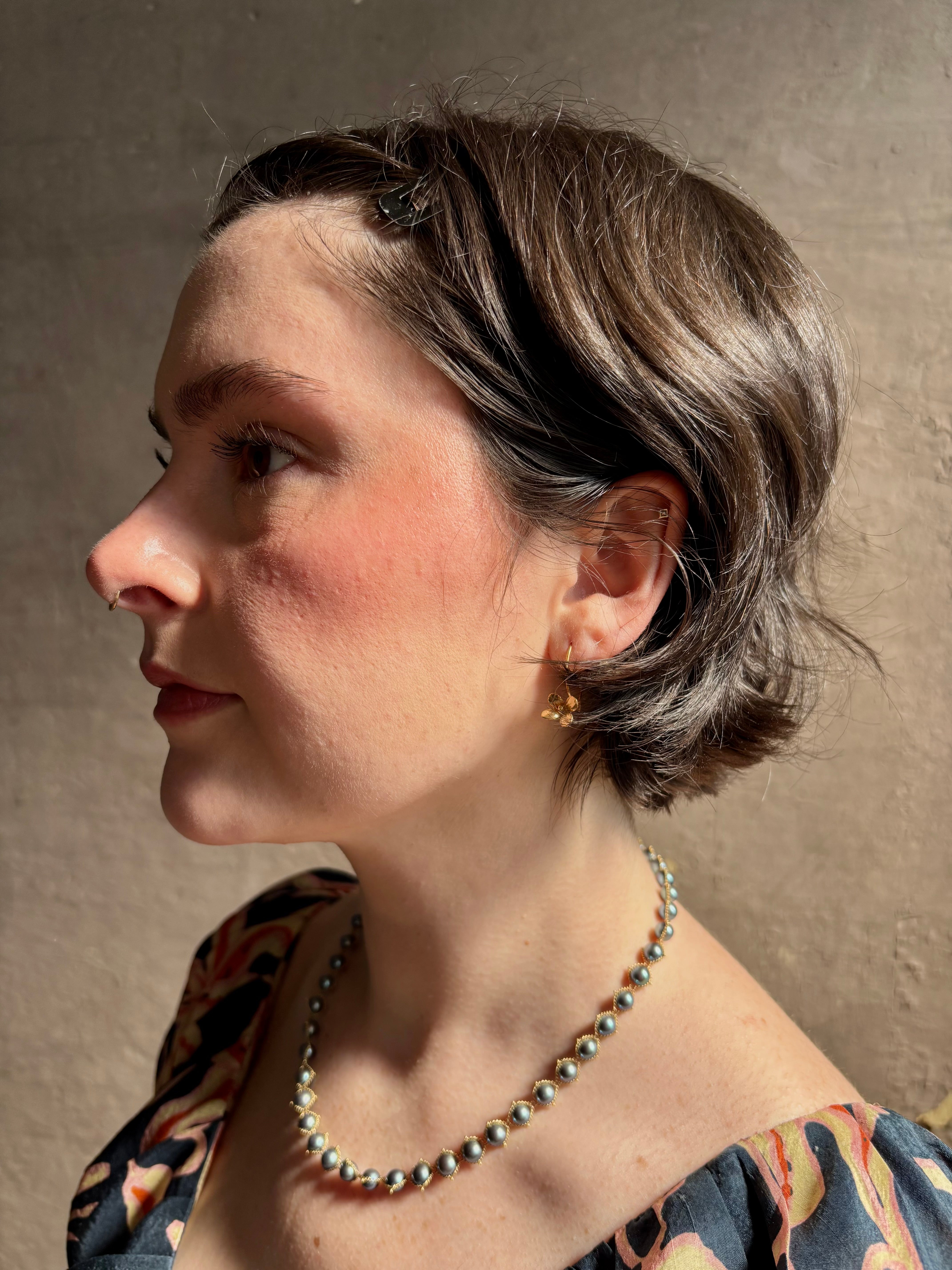 Woman wearing Purslane Rosette Hoop Earrings from North Carolina fine jewelry artist Amber Mahler  handcrafted in 18K yellow gold vermeil cast directly from the purslane rosette