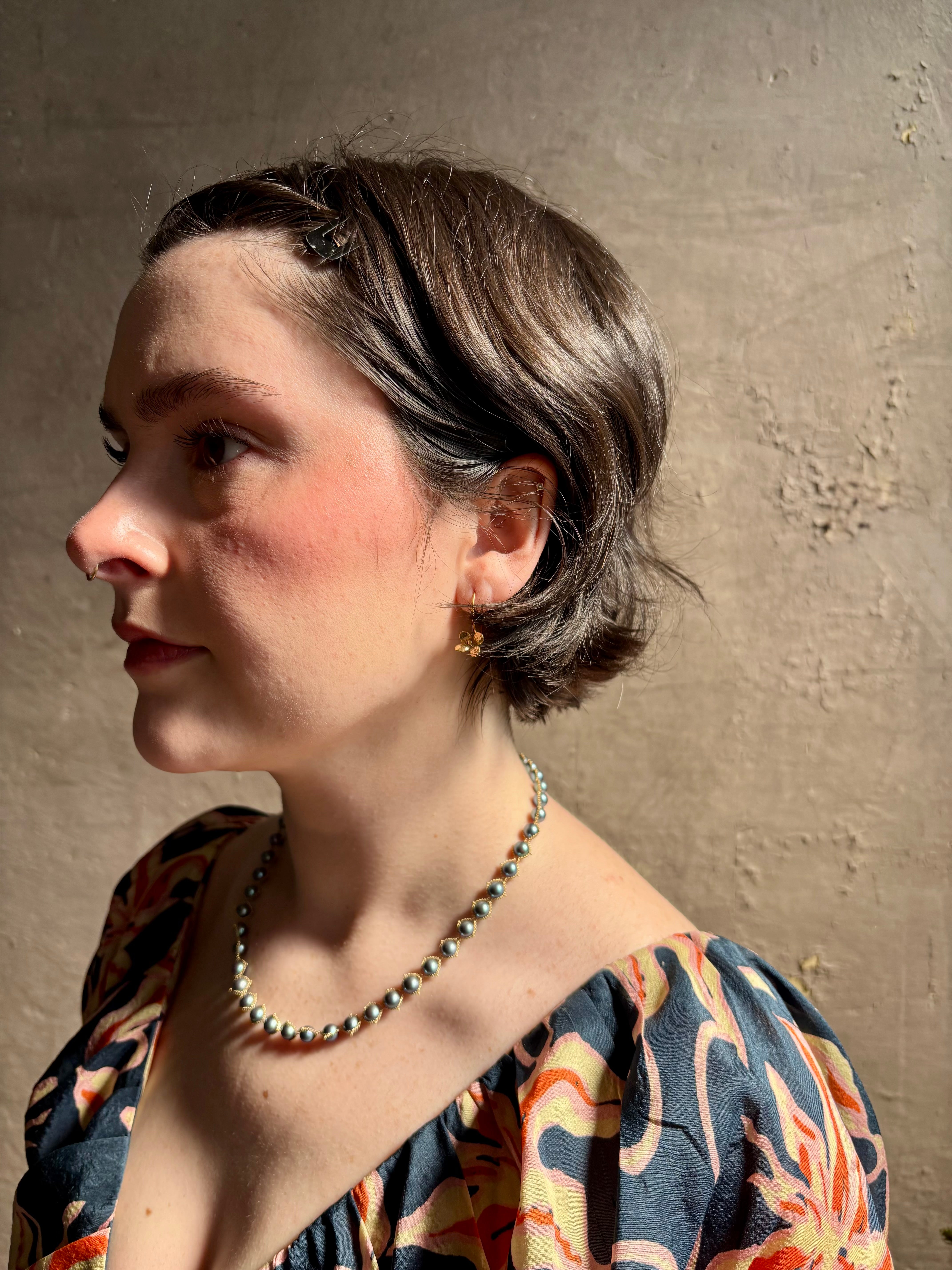 Woman wearing Purslane Rosette Hoop Earrings from North Carolina fine jewelry artist Amber Mahler  handcrafted in 18K yellow gold vermeil cast directly from the purslane rosette