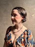 Woman wearing Silver Bells Hoop Earrings from North Carolina fine jewelry artist Amber Mahler in an exquisitely handcrafted 18K yellow gold vermeil botanical casting