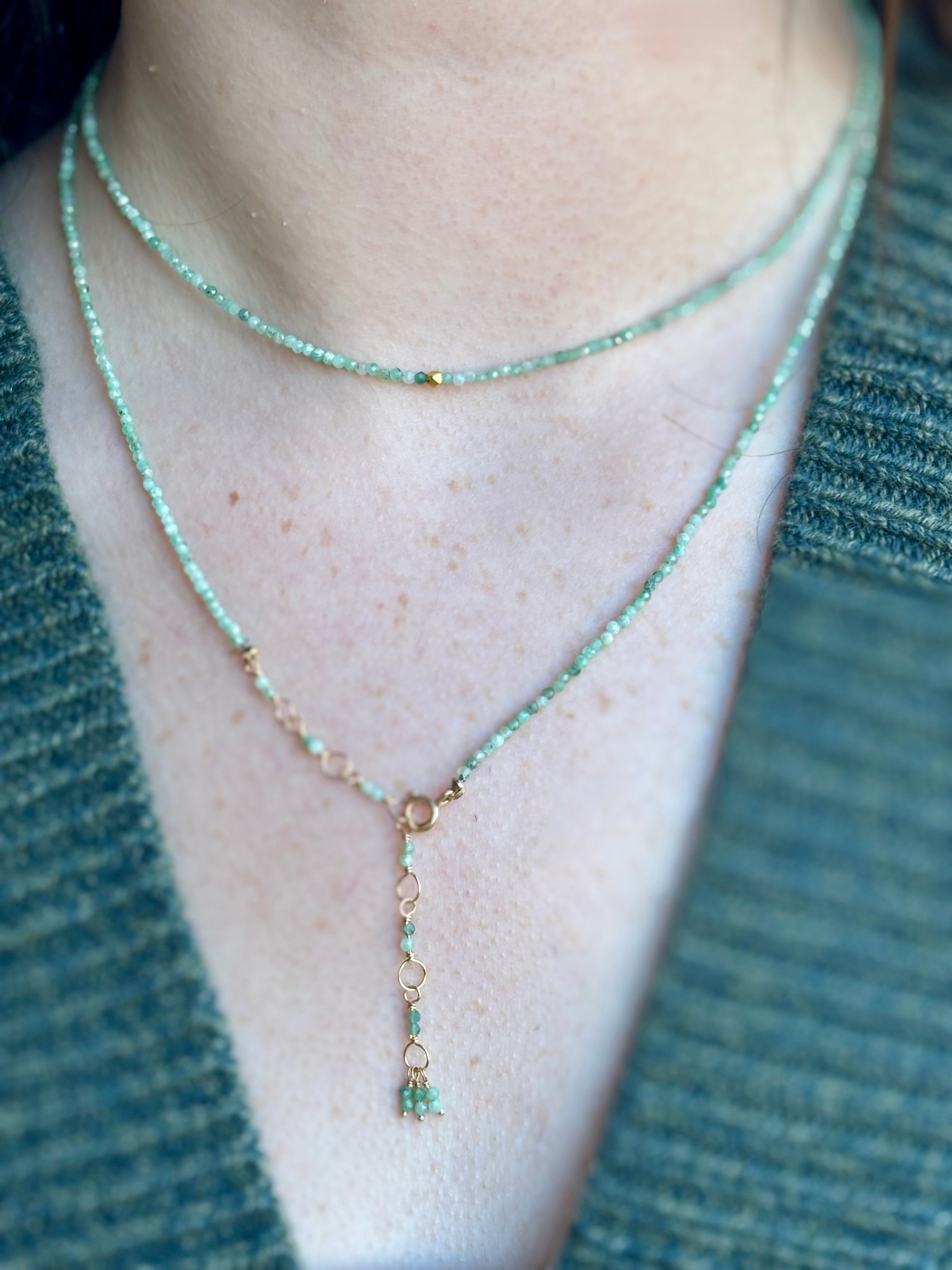 Image of woman wearing Canadian fine jewelry designer ANNE SPORTUN Emerald Wrap Bracelet in 18K Yellow Gold can also be worn as a necklace