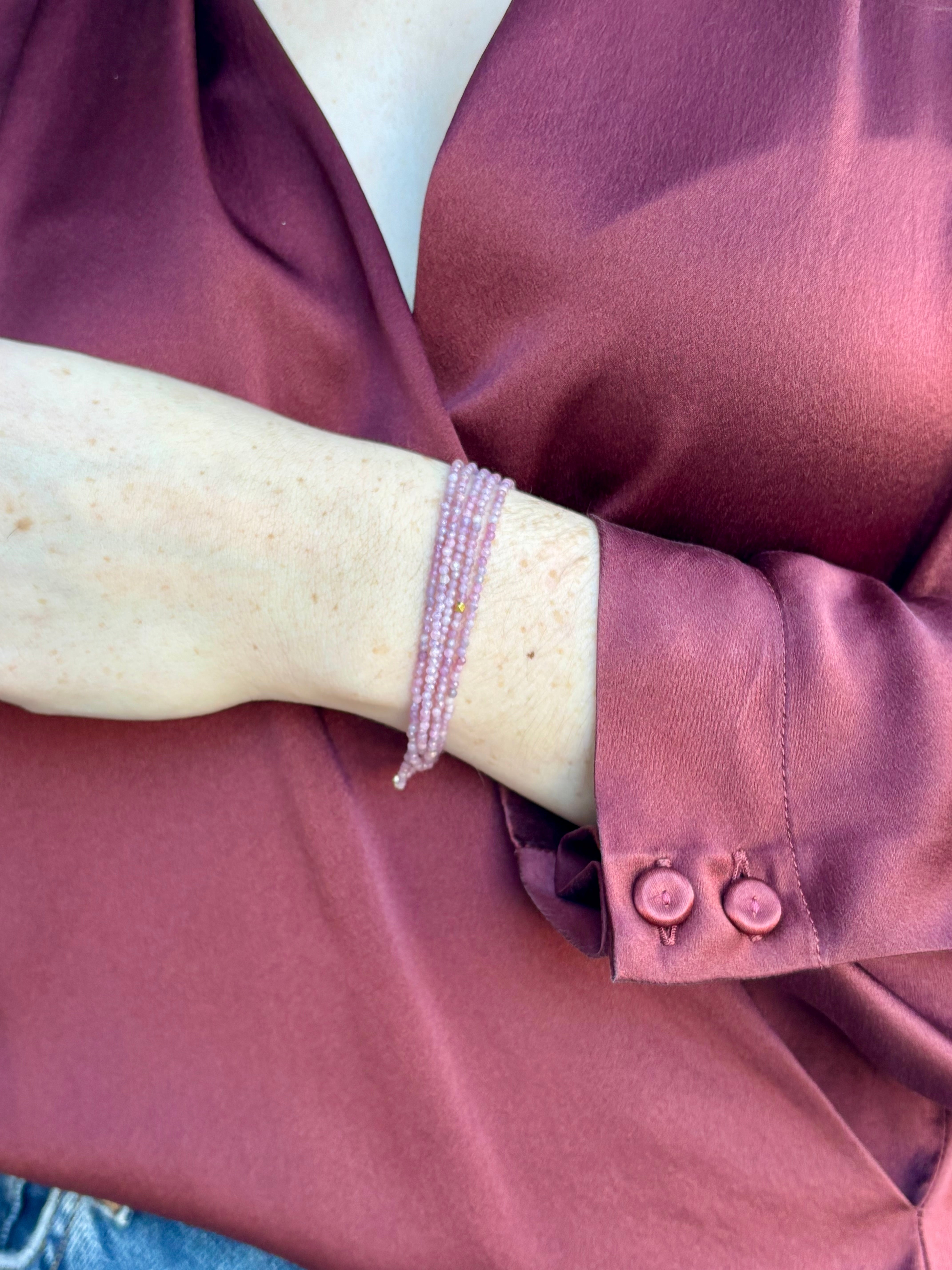 Image of woman wearing Candian jewelry designer ANNE SPORTUN Multi Pink Ruby Wrap Bracelet with 18K Yellow Gold spring clasp