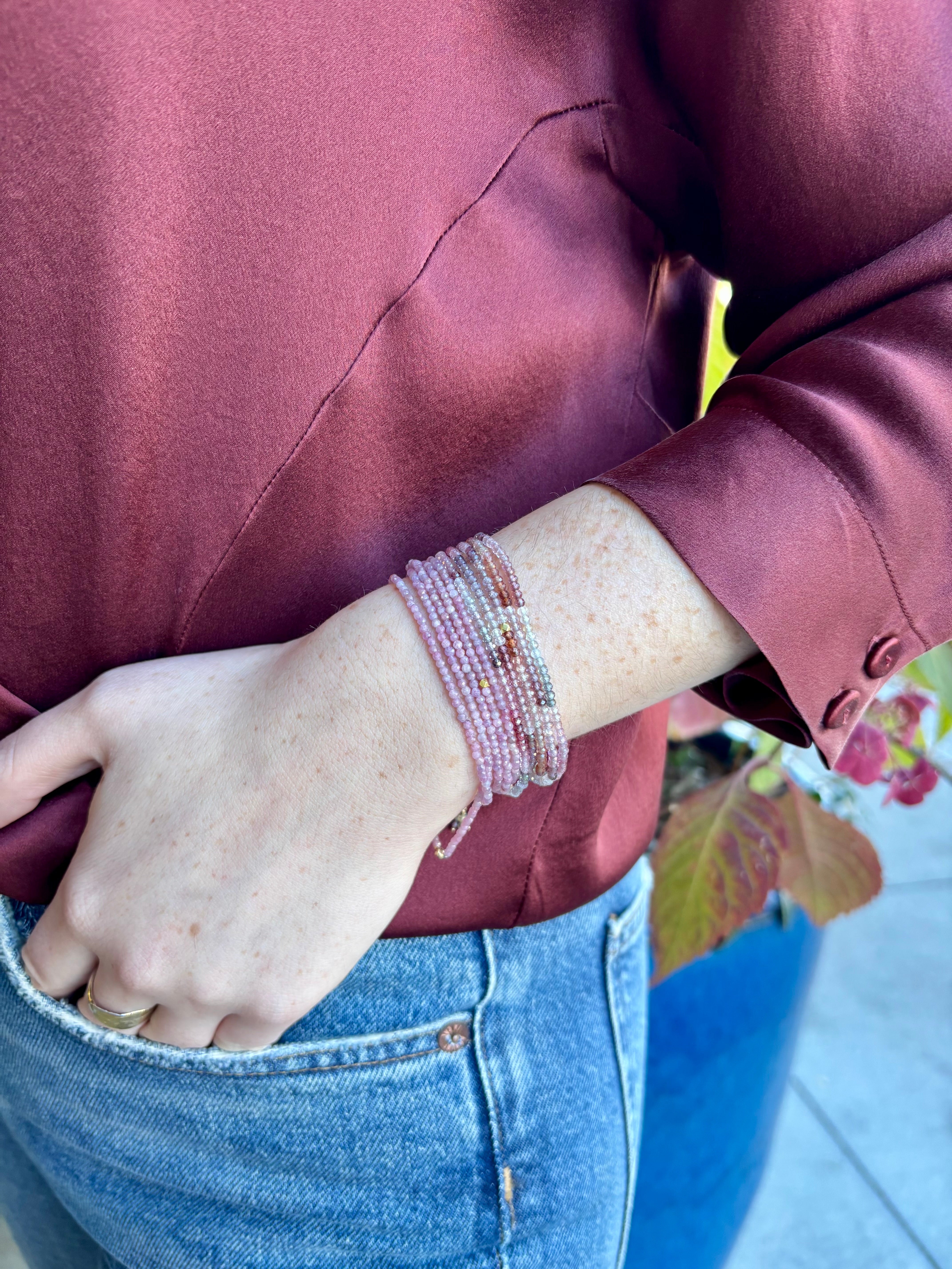 Image of woman wearing Candian jewelry designer ANNE SPORTUN Multi Pink Ruby Wrap Bracelet with 18K Yellow Gold spring clasp