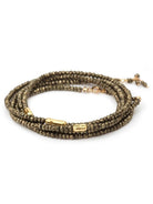 Woman wearing Pyrite River wrap Bracelet from Canadian fine jewelry artist Anne Sportun with pyrite and 18k yellow gold beads that can double as a necklace perfect for travel