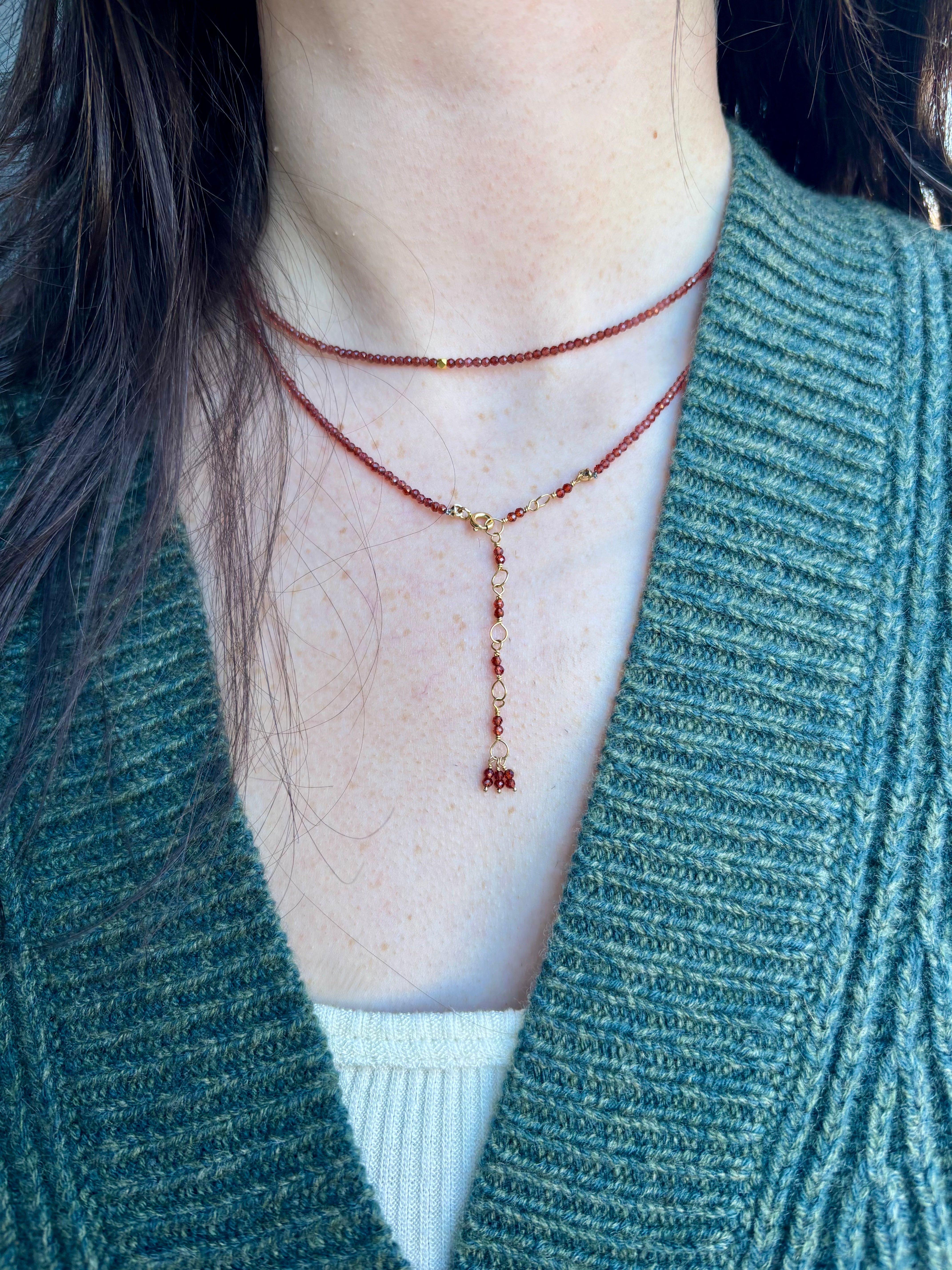 Image of a woman wearing designer Anne Sportun wrap bracelet as a layering necklace for a multi-purpose jewelry perfect for traveling