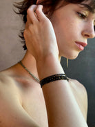 Woman wearing spinel confetti wrap Bracelet from Canadian fine jewelry artist Anne Sportun with natural stone spinel and 18k yellow gold beads that can double as a necklace perfect for travel