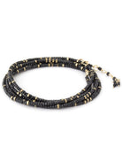 Woman wearing spinel confetti wrap Bracelet from Canadian fine jewelry artist Anne Sportun with natural stone spinel and 18k yellow gold beads that can double as a necklace perfect for travel