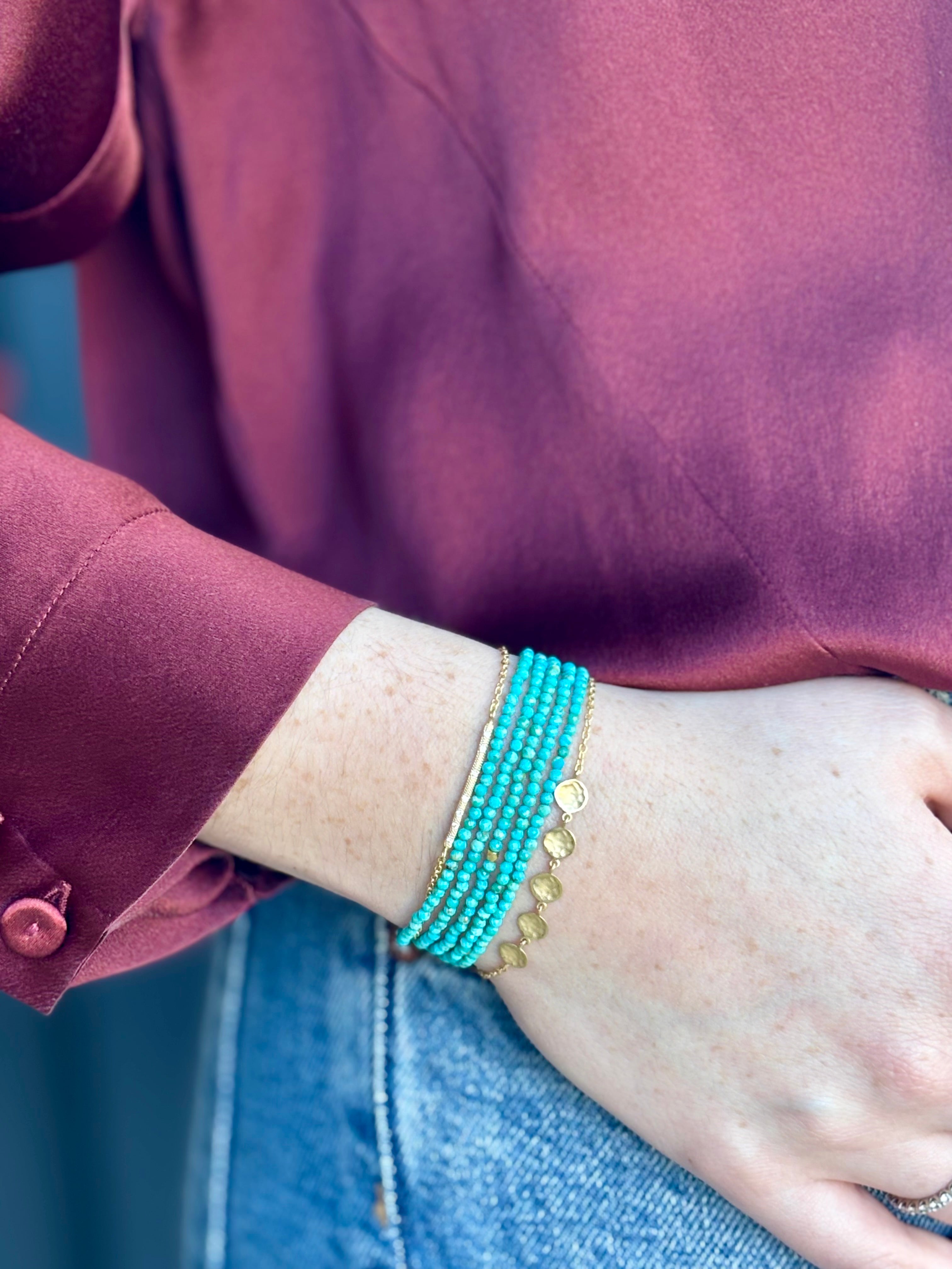 Image of woman wearing Canadian fine Jewelry designer ANNE SPORTUN Bracelet stack with 18K Yellow Gold, diamonds, and turquoise