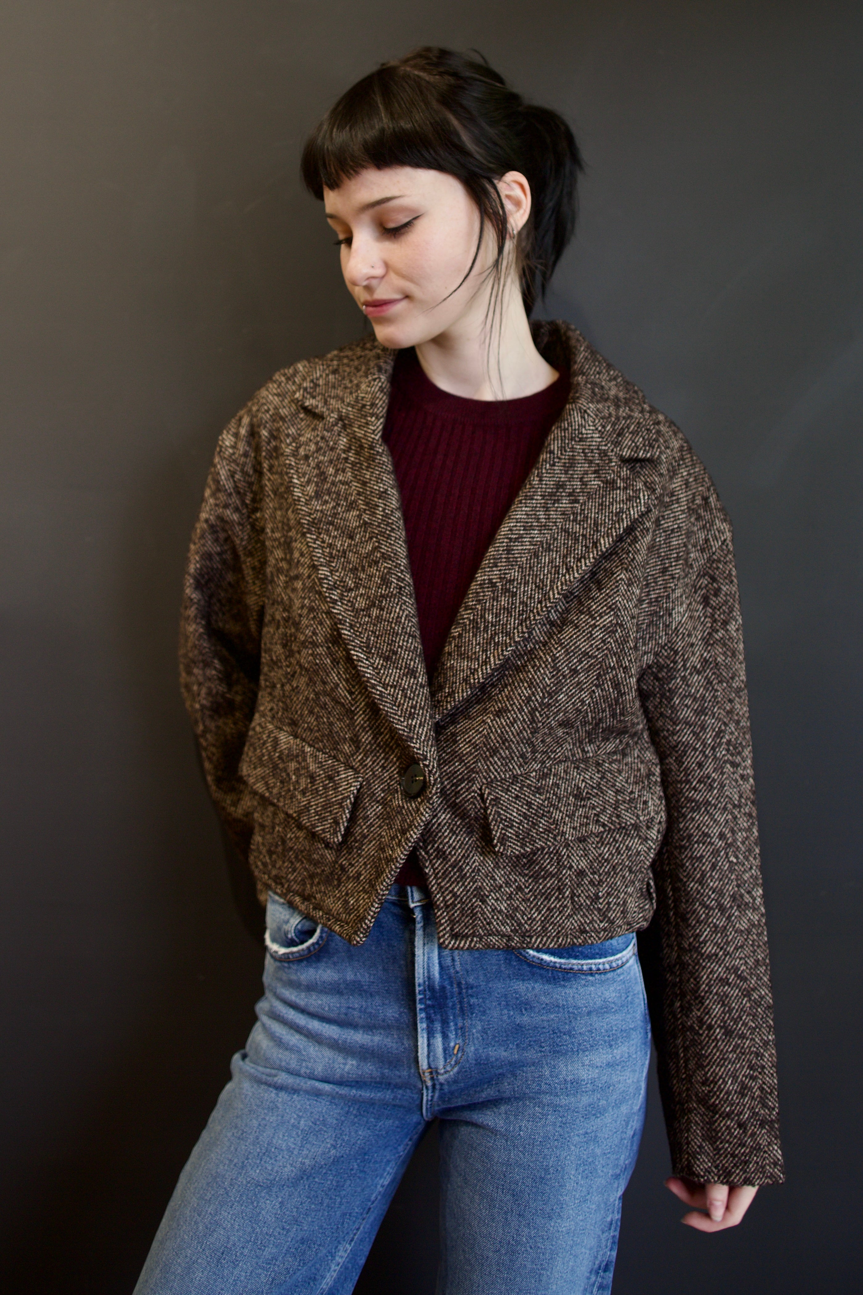 Model wearing Apiece Apart Ria  jacket in a brown textured herringbone with front flap pockets