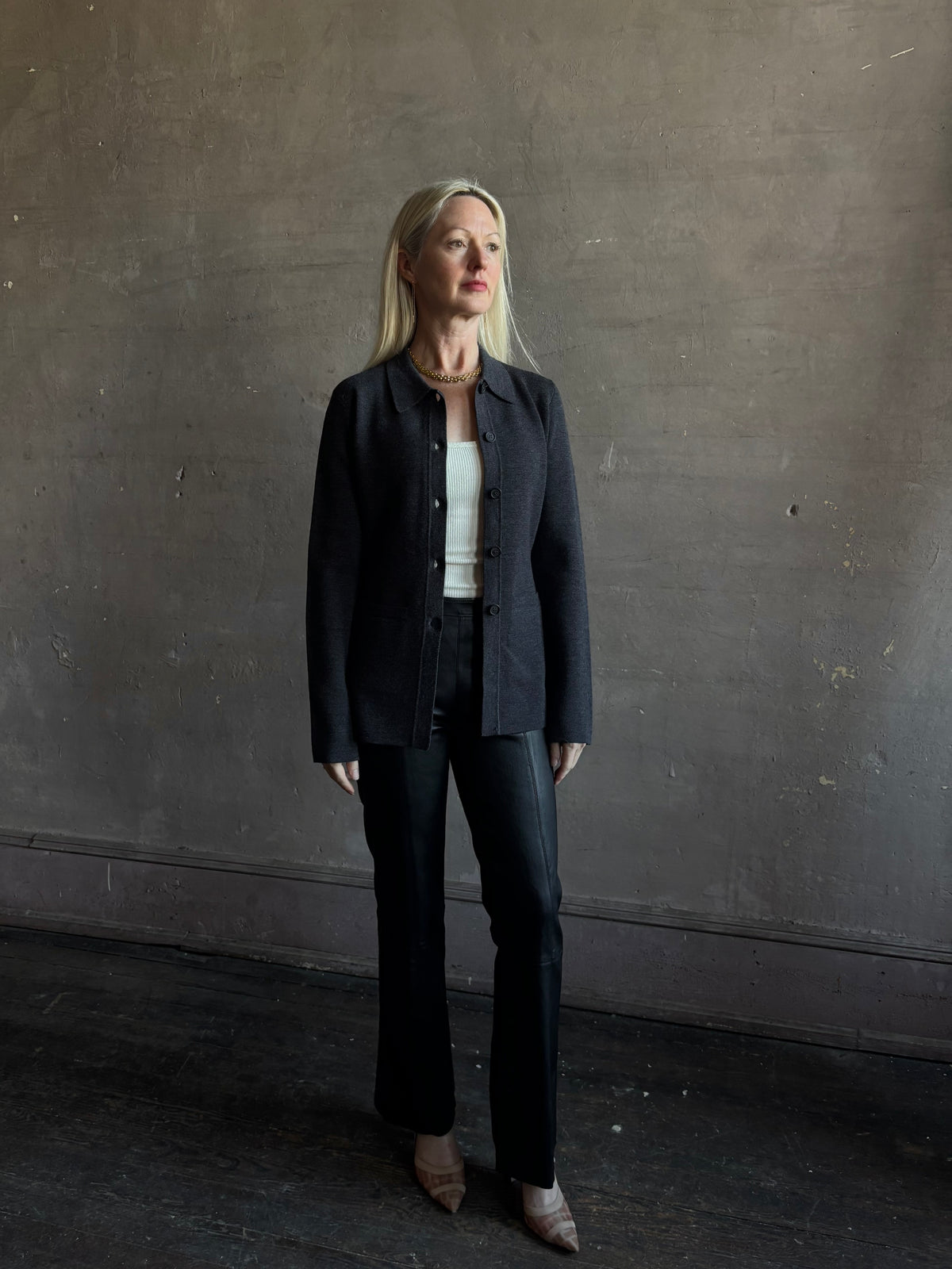 Mature woman wearing Apiece Apart Betti Knit Cardigan in Grey merino wool collared jacket-style silhouette front pockets everyday layering