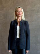 Mature woman wearing Apiece Apart Betti Knit Cardigan in Grey merino wool collared jacket-style silhouette front pockets everyday layering