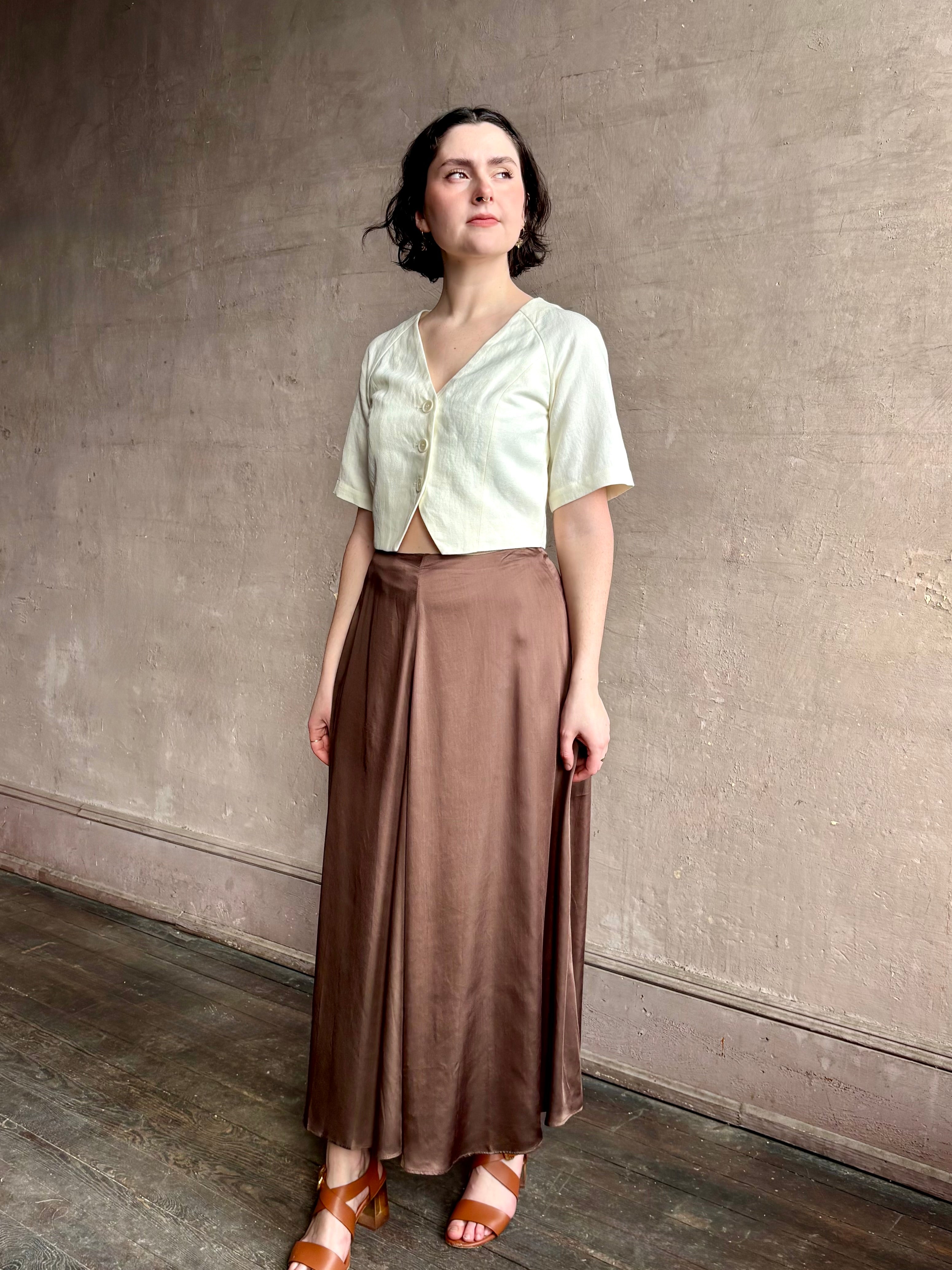 Woman wearing an elevated cream Lia designer Crop Top from Apiece Apart crafted in a breathable summer blend of organic cotton and linen