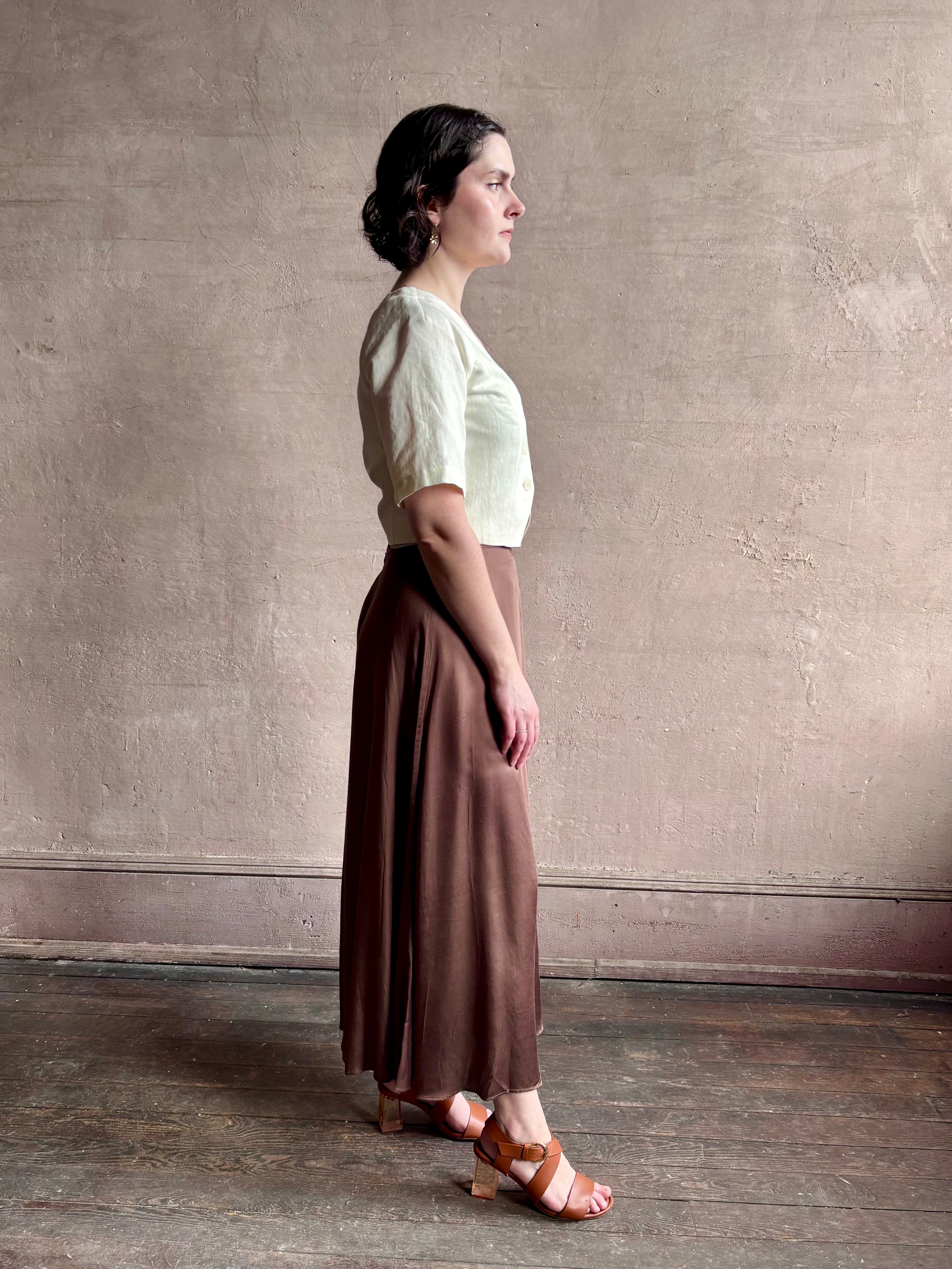 Woman wearing an elevated cream Lia designer Crop Top from Apiece Apart crafted in a breathable summer blend of organic cotton and linen