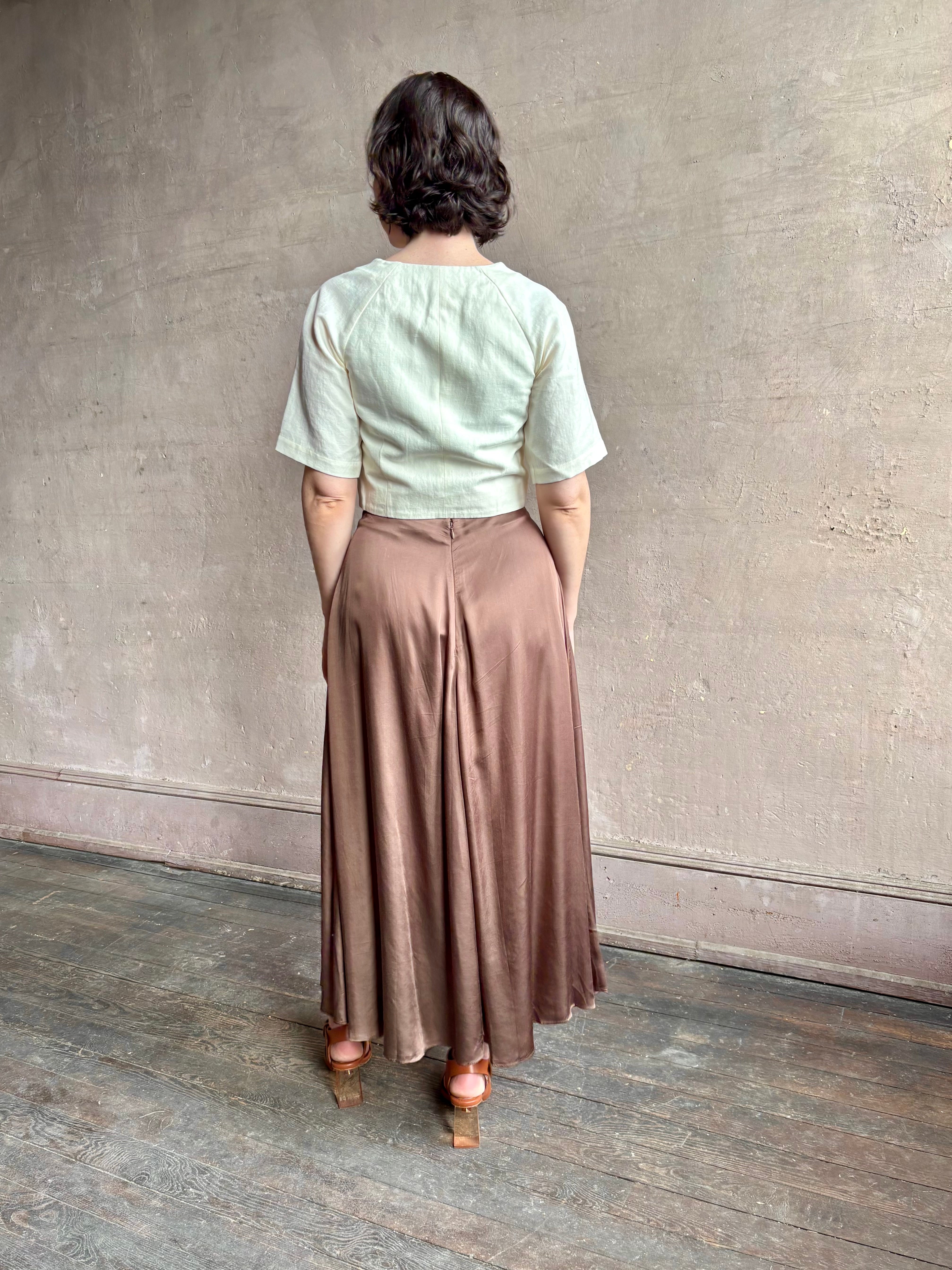 Woman wearing an elevated cream Lia designer Crop Top from Apiece Apart crafted in a breathable summer blend of organic cotton and linen