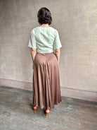 Woman wearing an elevated cream Lia designer Crop Top from Apiece Apart crafted in a breathable summer blend of organic cotton and linen