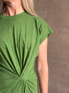 Mature woman wearing Volta Twist maxi Dress from Apiece Apart in a comfy green organic cotton jersey with short sleeves and crew neck
