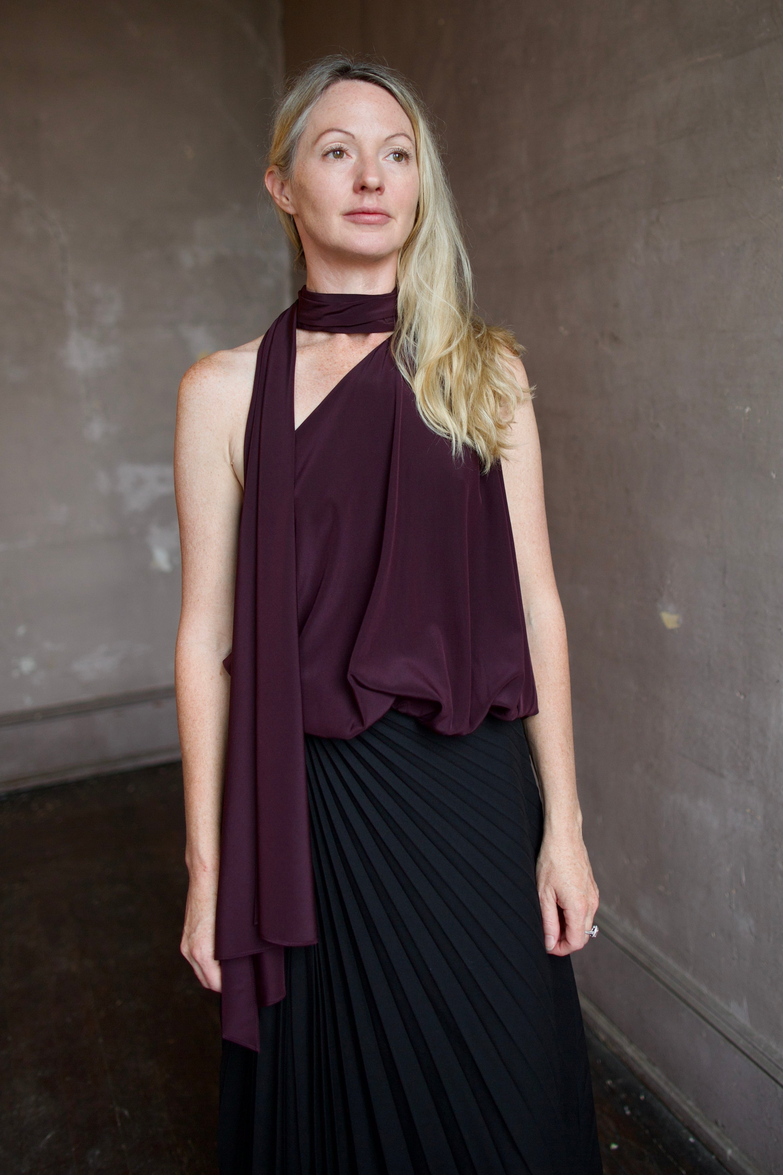 Mature model wearing the pleated tracy skirt and silk celeste top by ALC for a sophisticated date night outfit