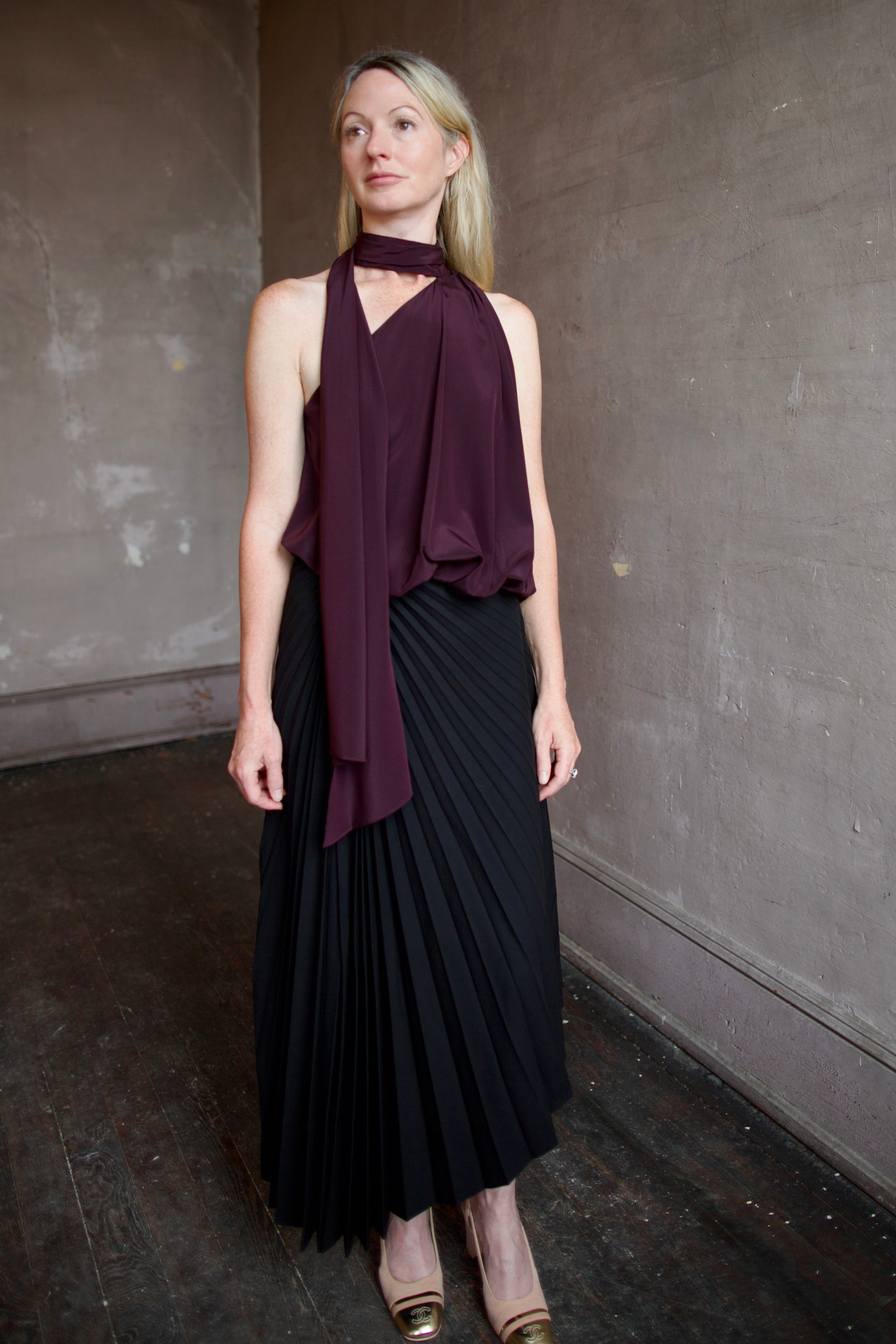 Mature model wearing the pleated tracy skirt and celeste top by ALC for a sophisticated date night outfit