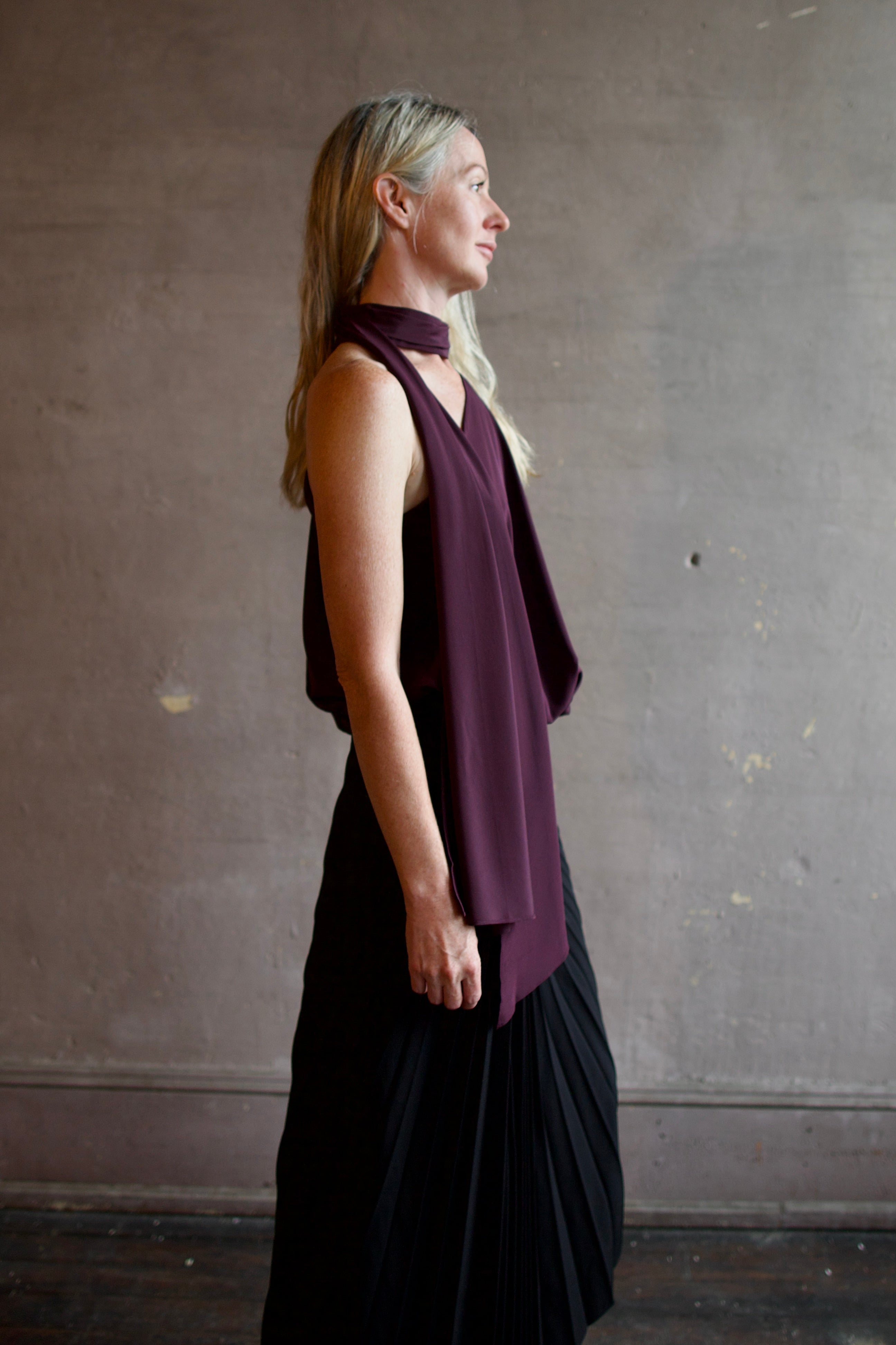 Profile image of model wearing the asymmetrical silk celeste top by ALC with attached sophisticated scarf detail