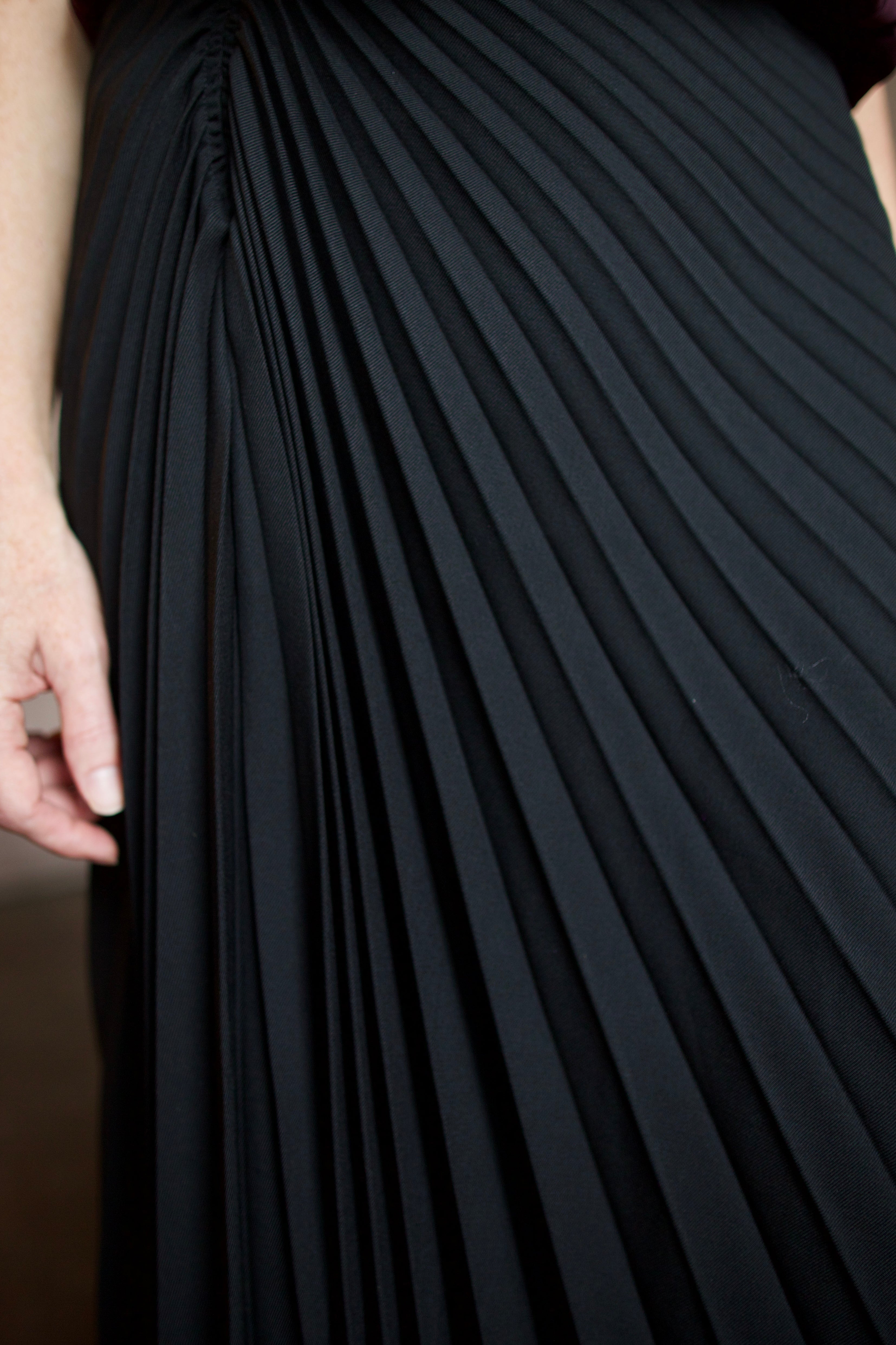 Detailed photo of the pleated tracy skirt in black wool by ALC portraying detailed design, style and quality