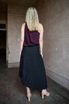 Mature model wearing the pleated tracy skirt and celeste top by ALC for a sophisticated date night outfit