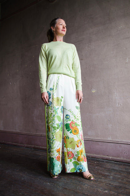 Image featuring a woman wearing the Constance pants by Alemais with a high rise and allover floral print, side stripes and pockets.