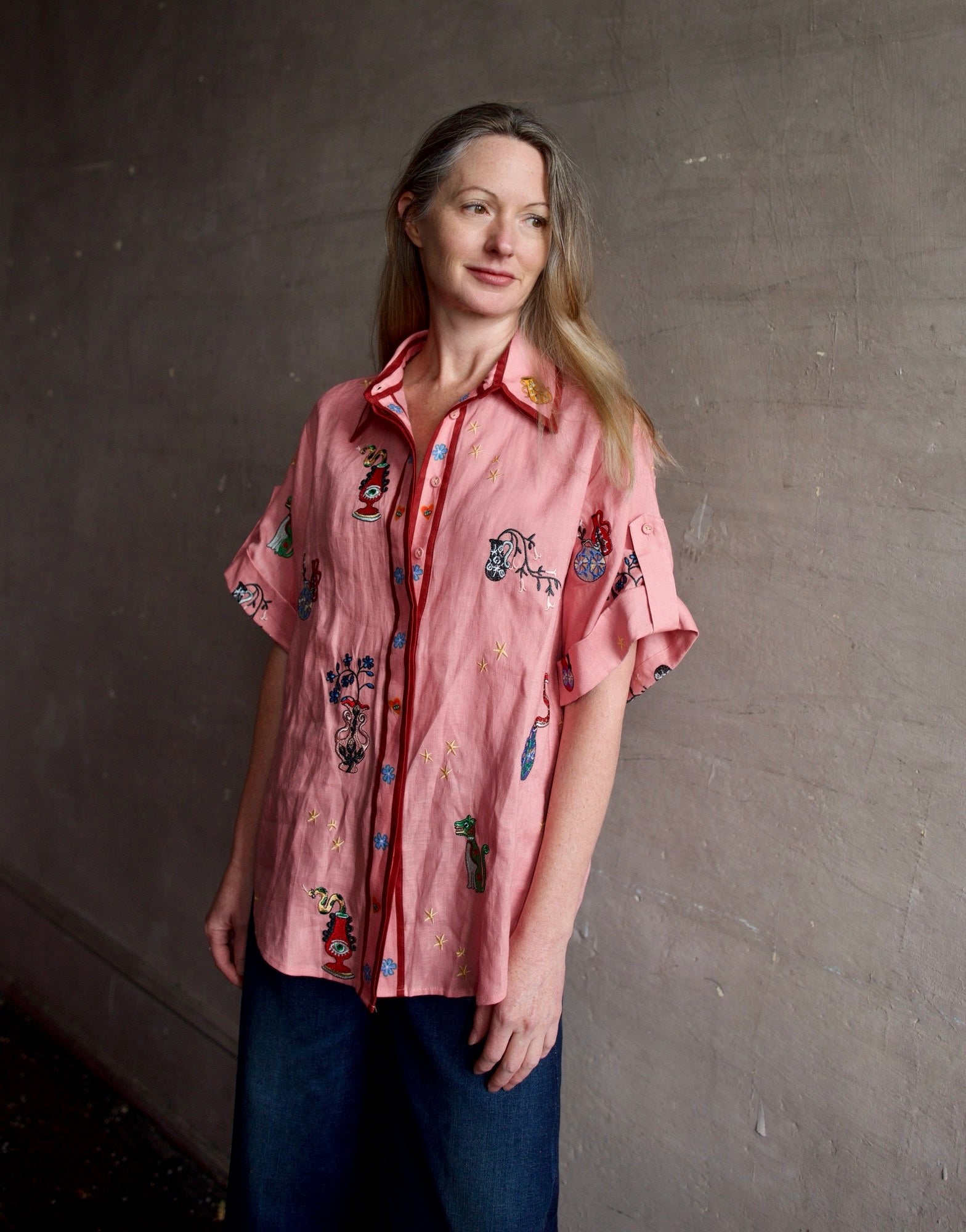 Image of a woman wearing the Alemais Timmy embroidered shirt and Re/Done Wide Leg crop jeans