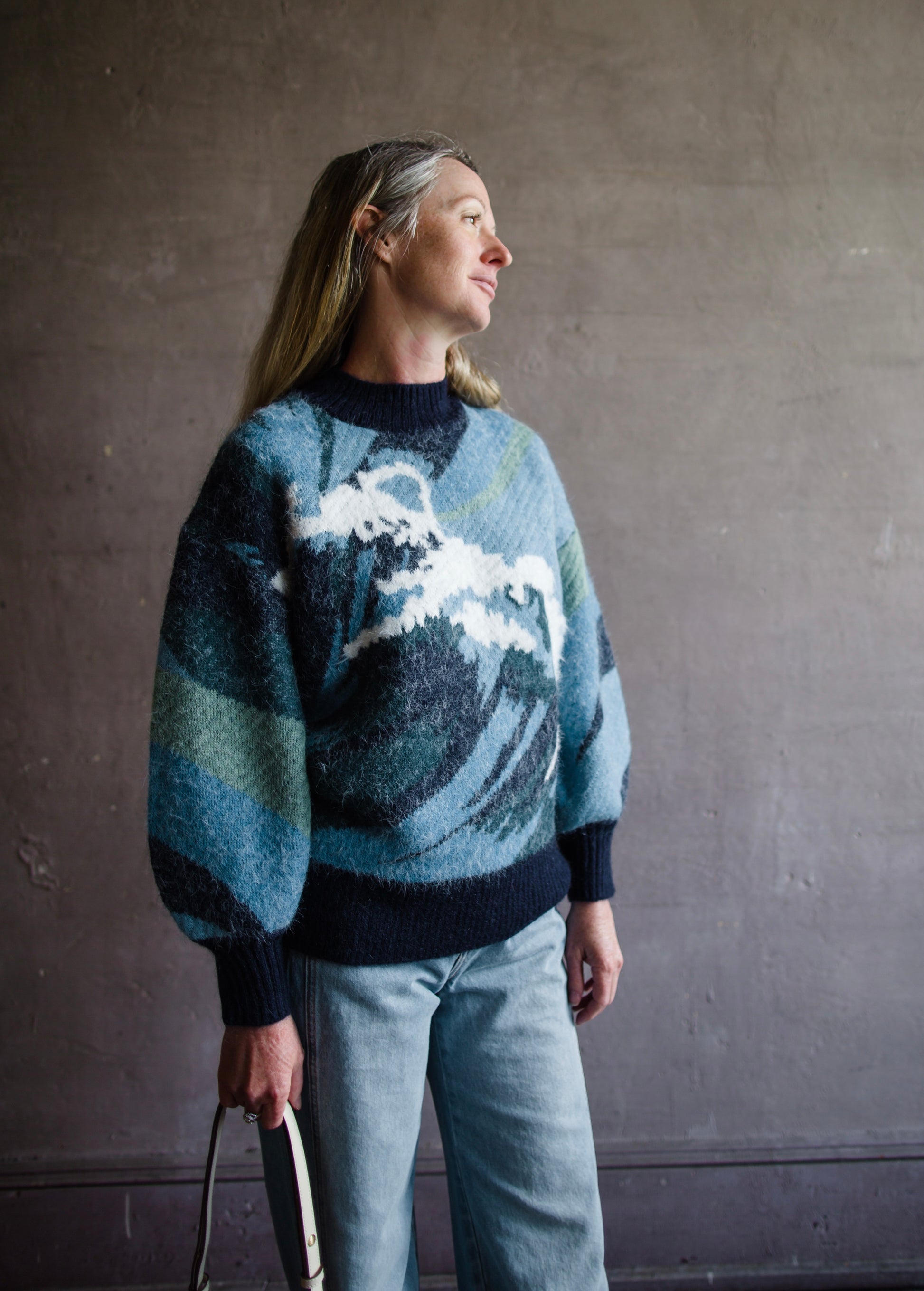 Image featuring a woman wearing the Wave knit sweater by Alemais with chunky texture with a wave pattern and full sleeves.