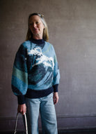 Image featuring a woman wearing the Wave knit sweater by Alemais with chunky texture with a wave pattern and full sleeves.