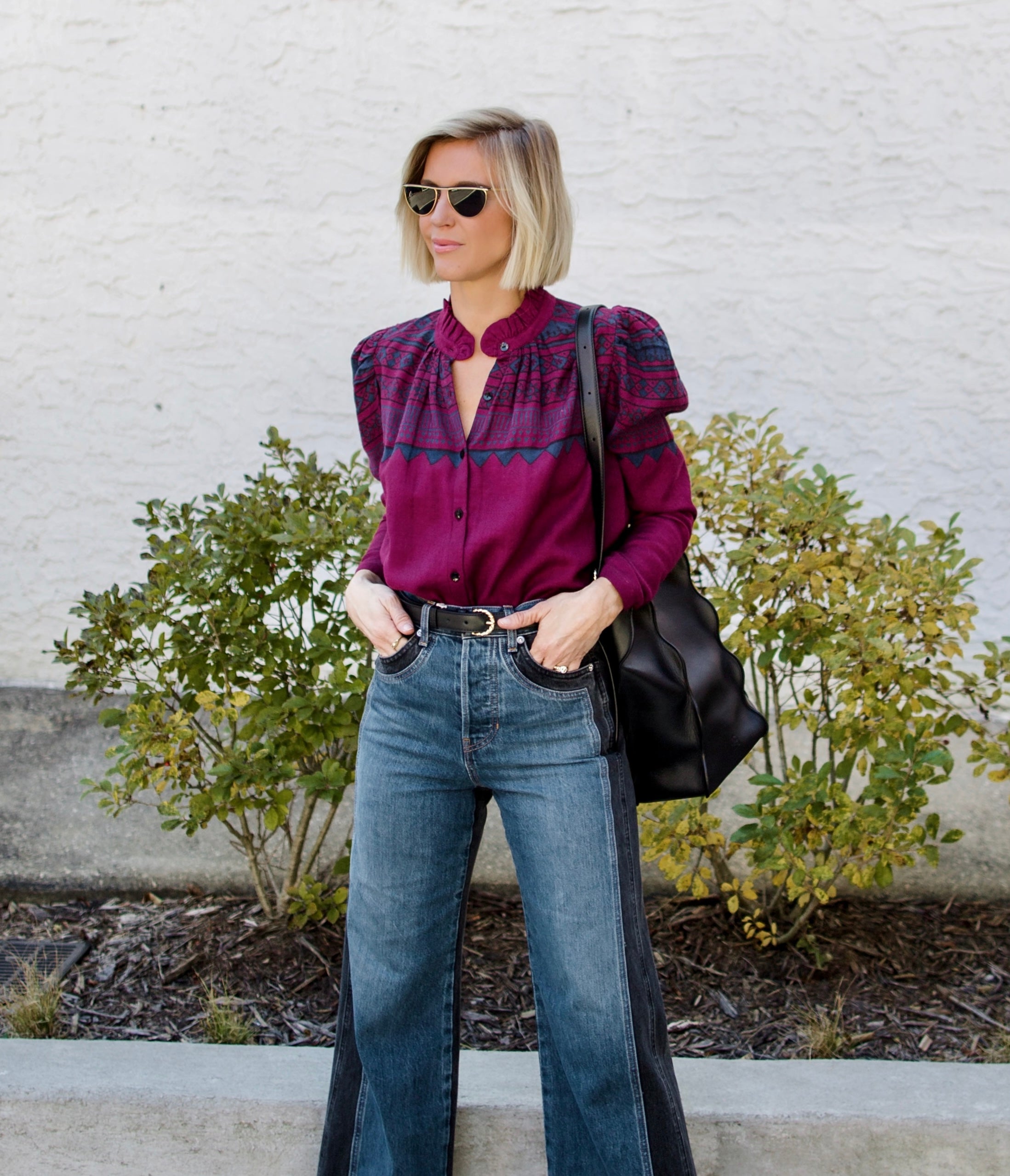 Image of a woman wearing the Alix of Bohemia Artemis Plum Fairisle top with a button front and puff shoulder long sleeves.