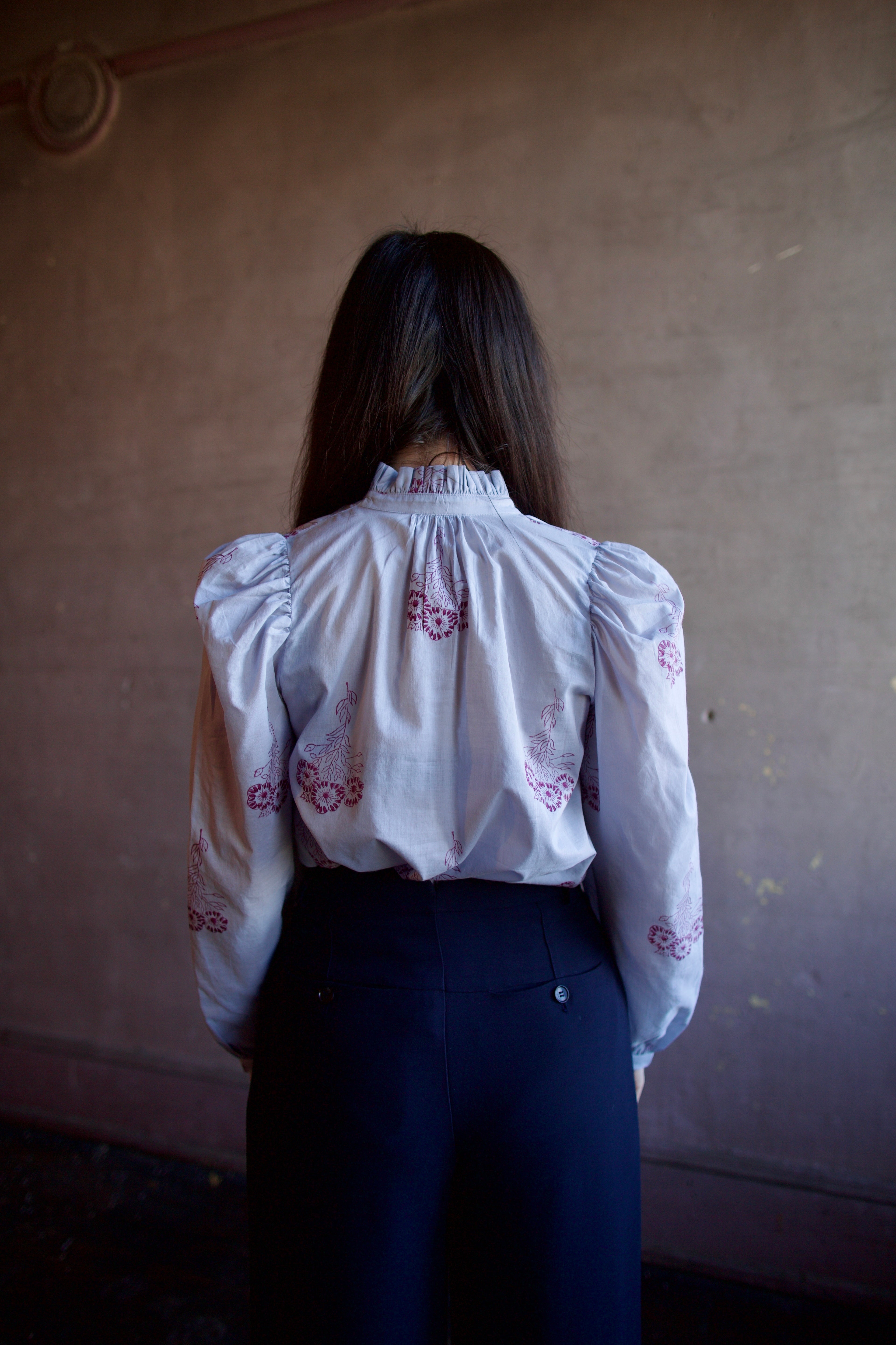 Woman wearing the alix of bohemia annabel pansy sky long sleeve cotton shirt expert handcrafted artistry perfect for elevated casual wear