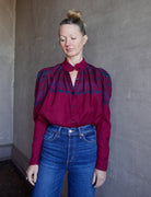 Image of a woman wearing the Alix of Bohemia Artemis Plum Fairisle top with a button front and puff shoulder long sleeves.