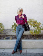 Image of a woman wearing the Alix of Bohemia Artemis Plum Fairisle top with a button front and puff shoulder long sleeves.