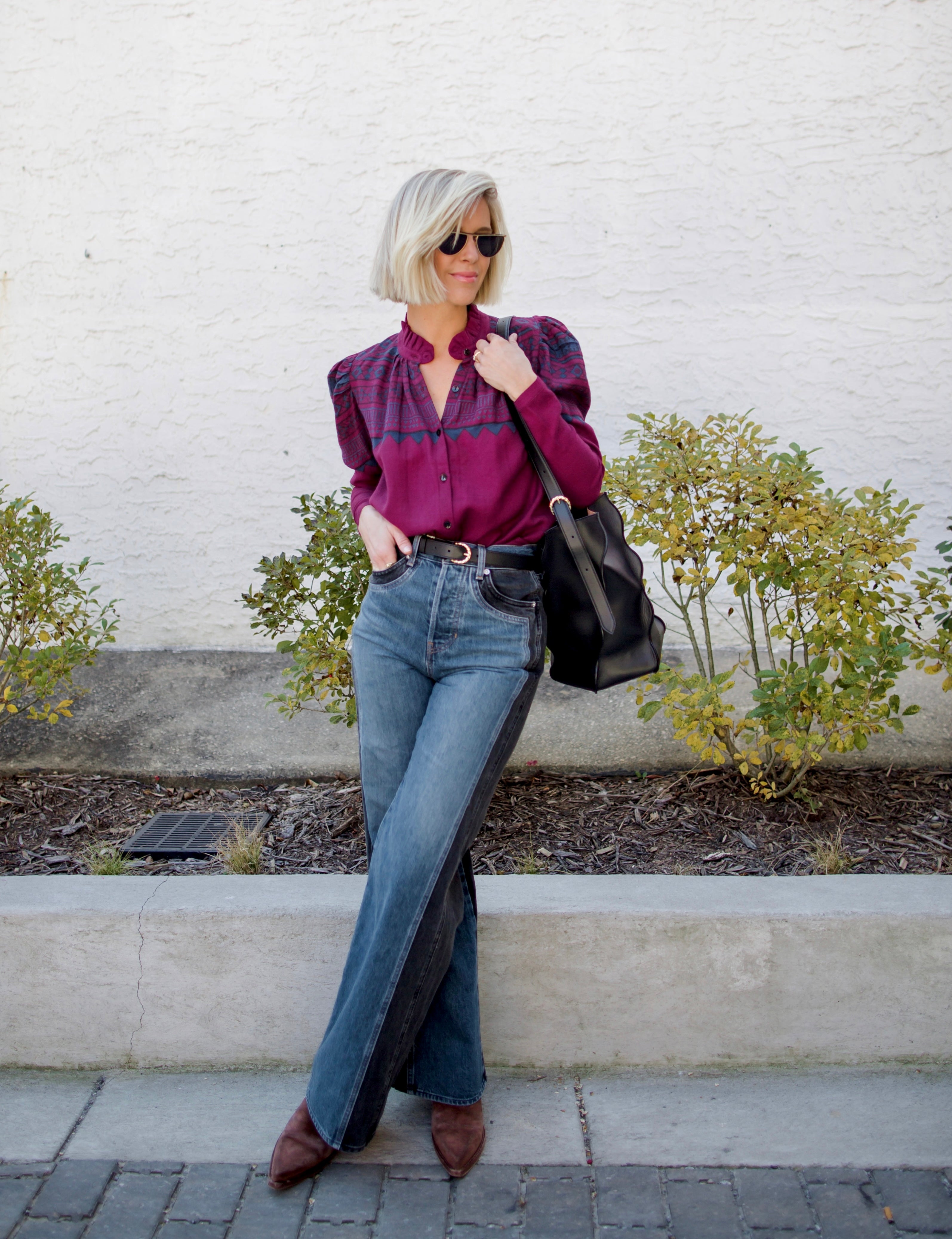 Image of a woman wearing the Alix of Bohemia Artemis Plum Fairisle top with a button front and puff shoulder long sleeves.