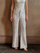 Woman wearing luxury designer Alix of Bohemia bunny toile linen trousers in white with blue print flare high rise