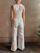 Woman wearing luxury designer Alix of Bohemia bunny toile summer weight linen trousers in white with blue print 