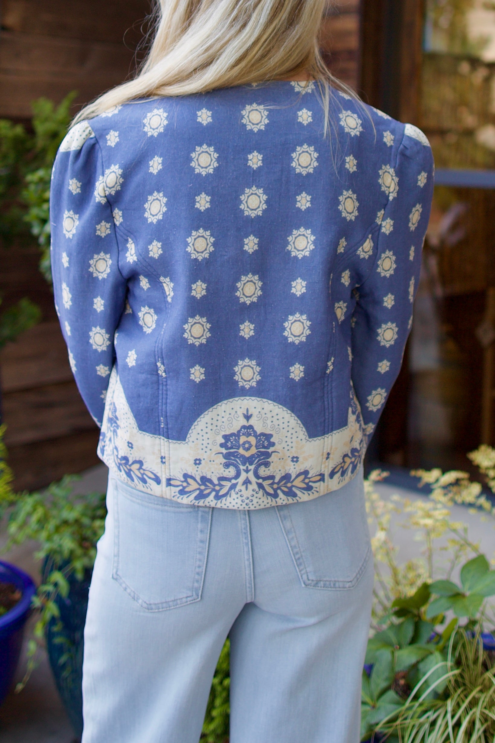 Model wearing luxury designer Alix of Bohemia Dorian jacket in blue marina bandana print with intricate details and feminine silhouette 