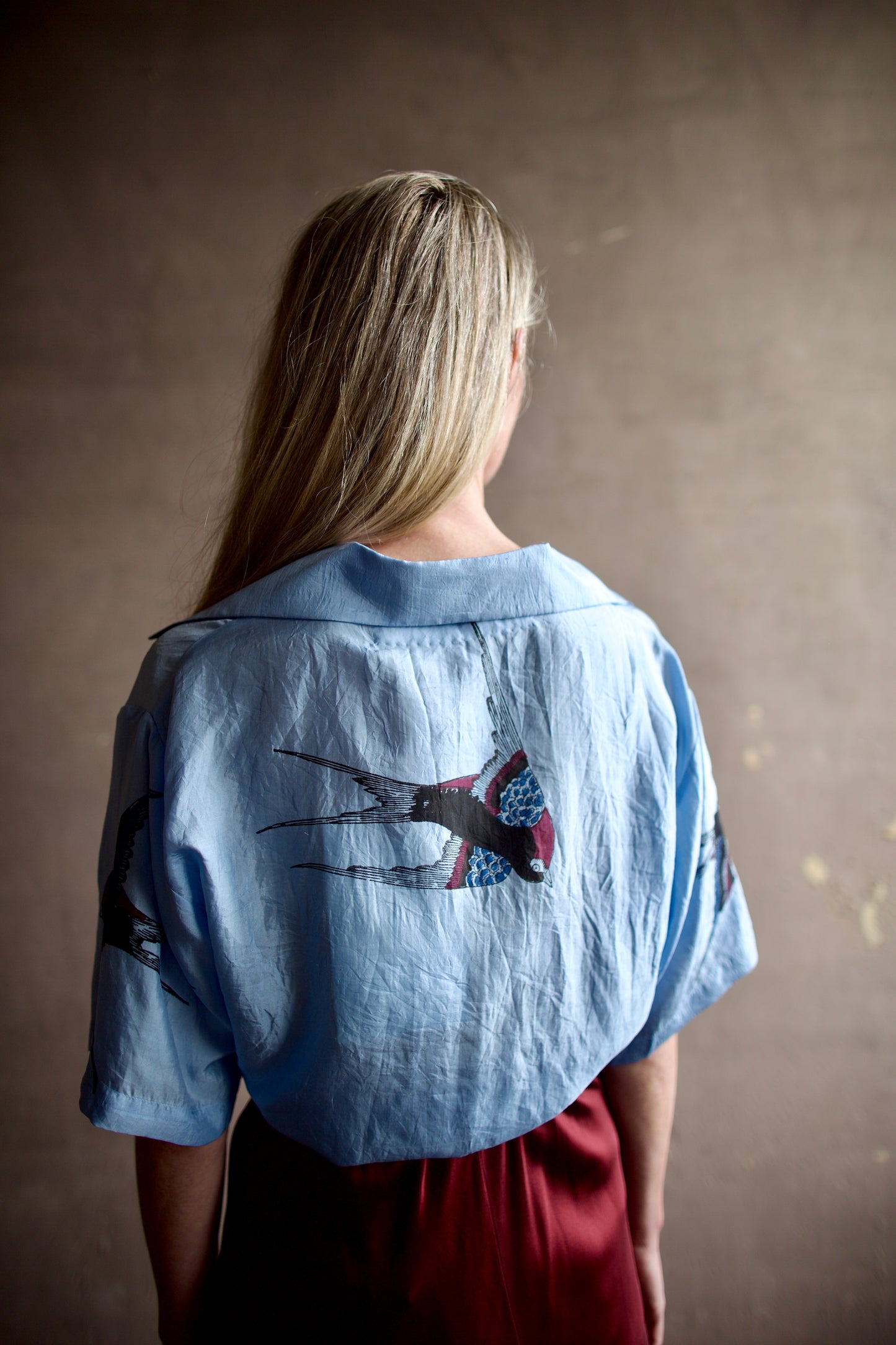 back image of a woman wearing the Alix of Bohemia Stevie Swallow Shirt