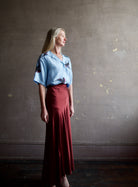 image of a woman wearing the Aix of Bohemia Stevie Swallow Shirt and Forte Forte Slip Skirt