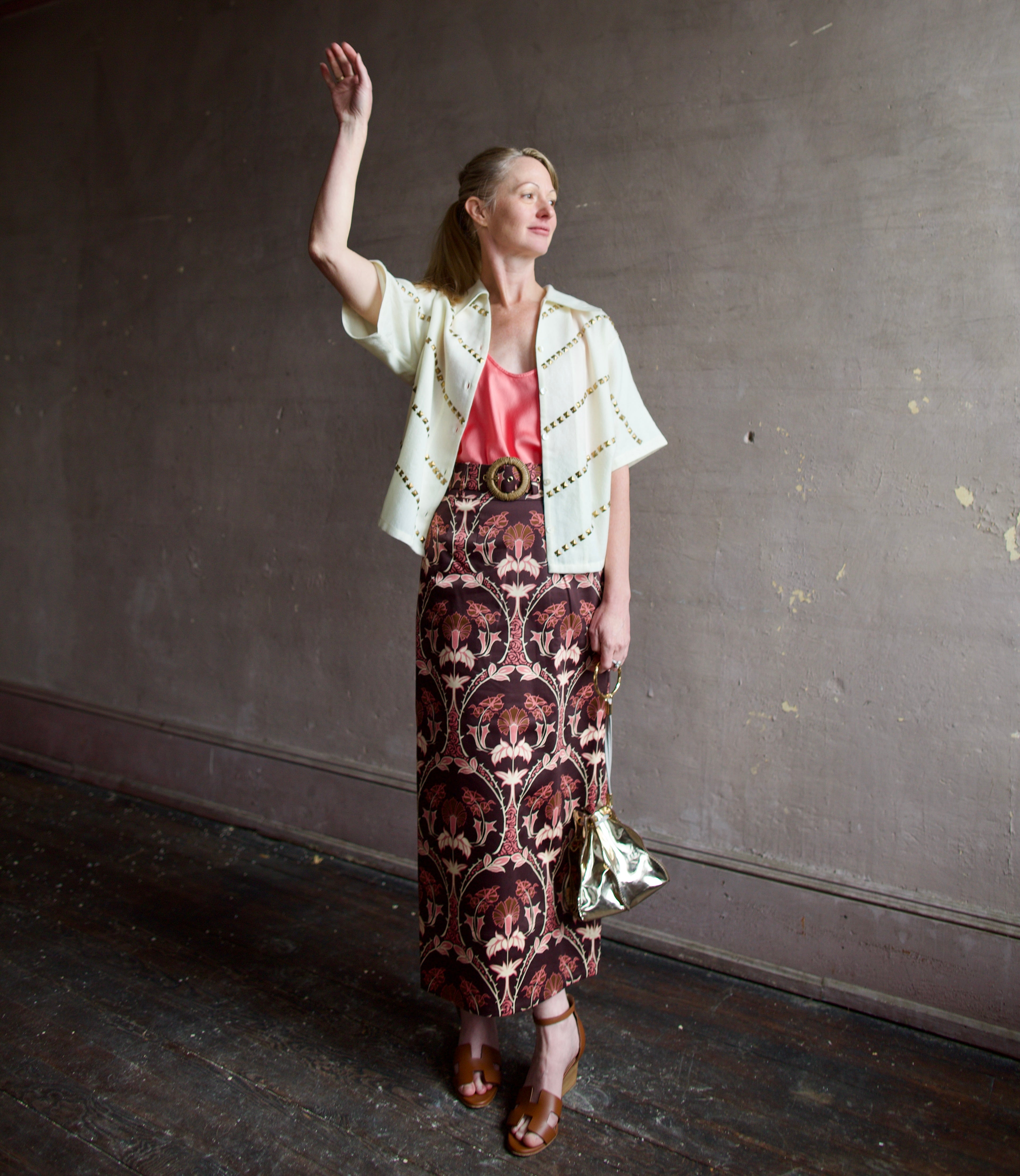 Image of a woman wearing the Alix of Bohemia Studded Shirt, Forte Forte Silk Tank and Cara Cara Printed Skirt