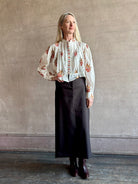 Image of woman Alix of Bohemia Ryland Persimmon Flower Shirt with long sleeves, button front, a mandarin collar and cropped