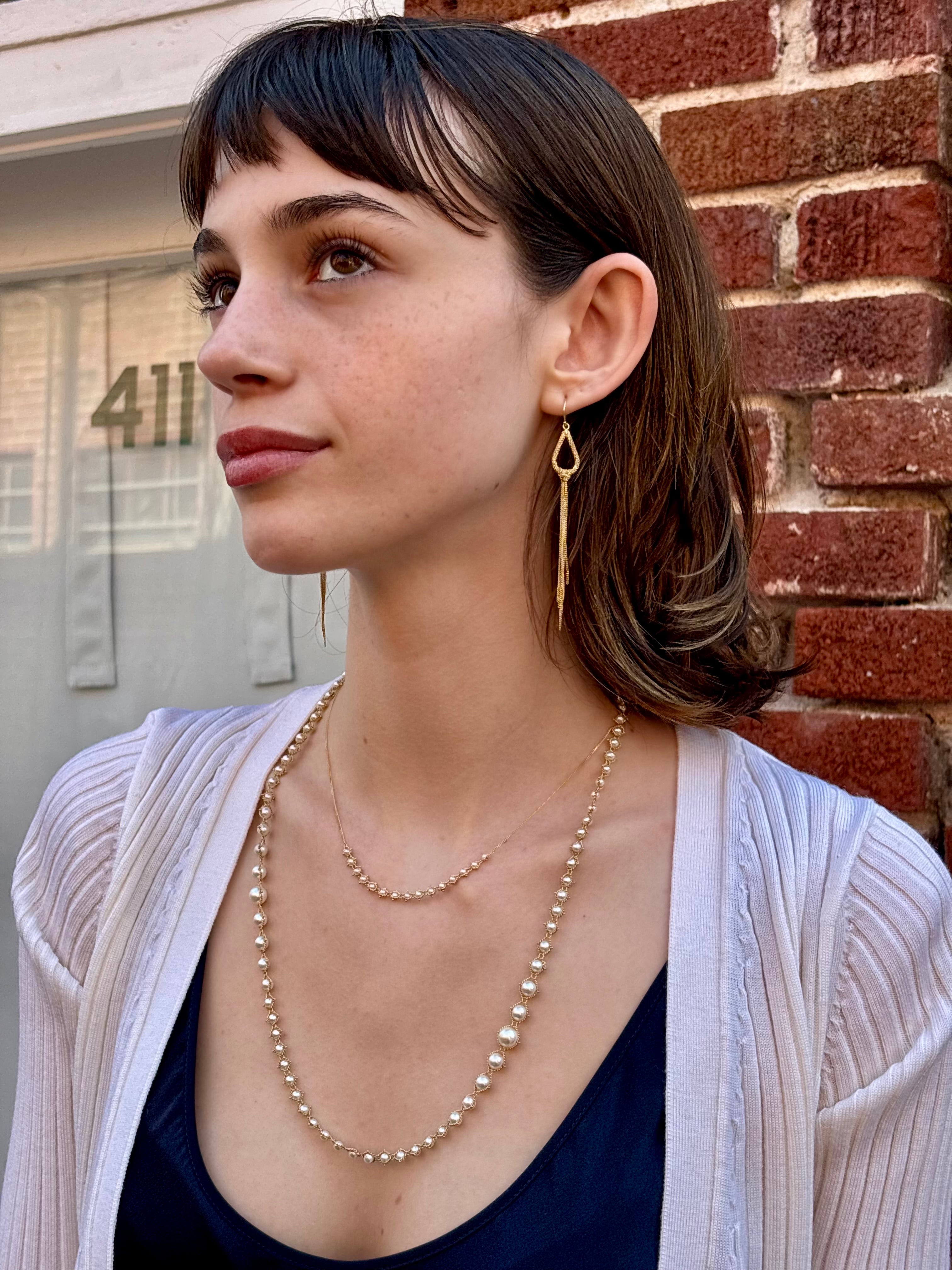 Woman wearing luxury designer Amali  hand woven long Akoya Pearl and 18k yellow  gold Necklace made in USA fine jewelry