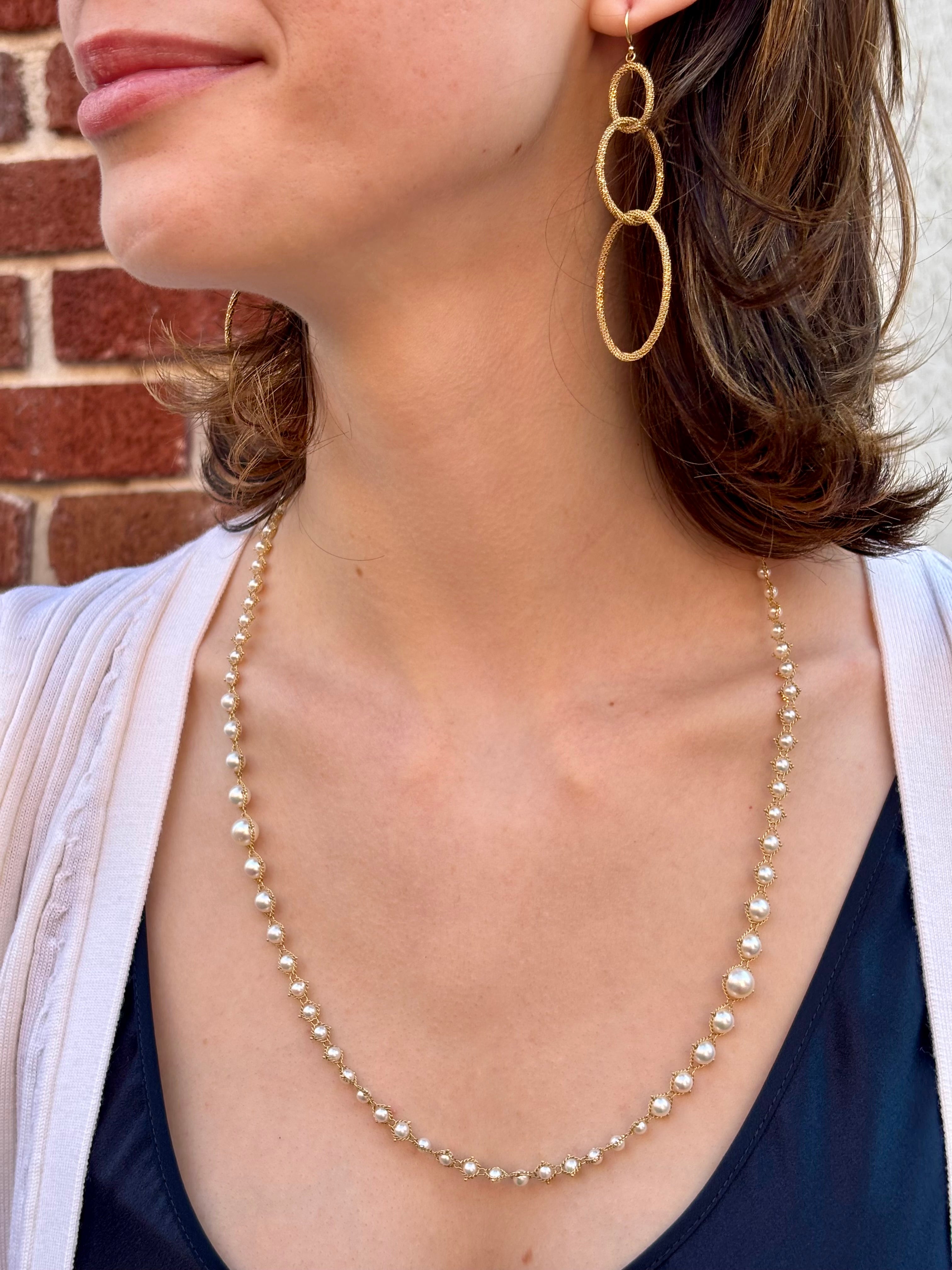 Woman wearing luxury designer Amali  hand woven long Akoya Pearl and 18k yellow  gold Necklace made in USA fine jewelry