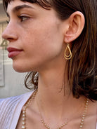 Woman wearing luxury designer Amali double Teardrop Stardust 18k yellow gold Earrings handmade in USA fine jewelry