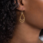 Woman wearing luxury designer Amali double Teardrop Stardust 18k yellow gold Earrings handmade in USA fine jewelry
