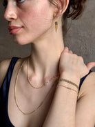 Woman wearing Amali Tassel silver diamond drop Earrings in 18k yellow gold in an inspiring 21st century modern design