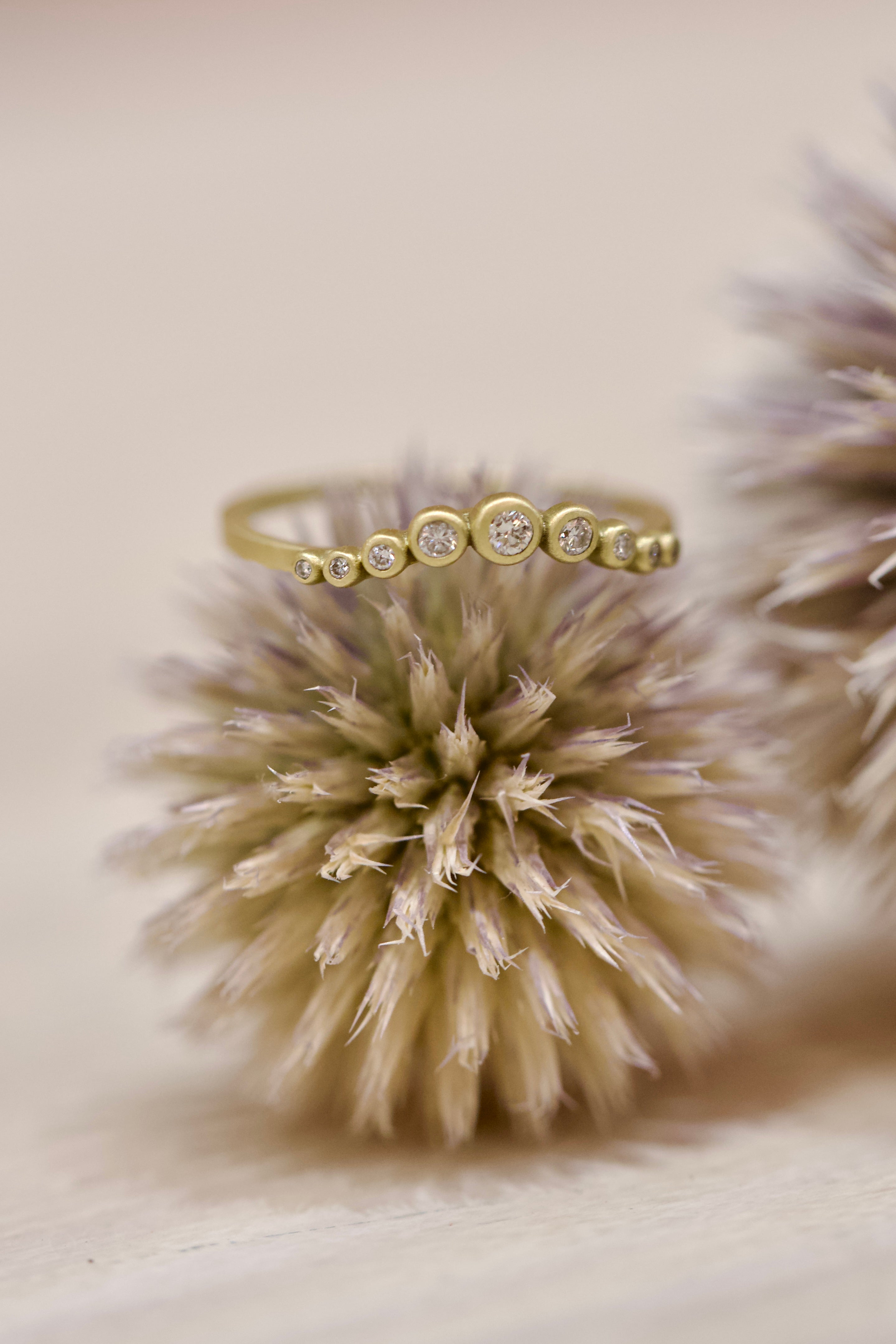 Image of Ananda Khalsa Graduated Curve with nine white Diamond 18k hammered Gold Band showcasing premium handcrafted construction 