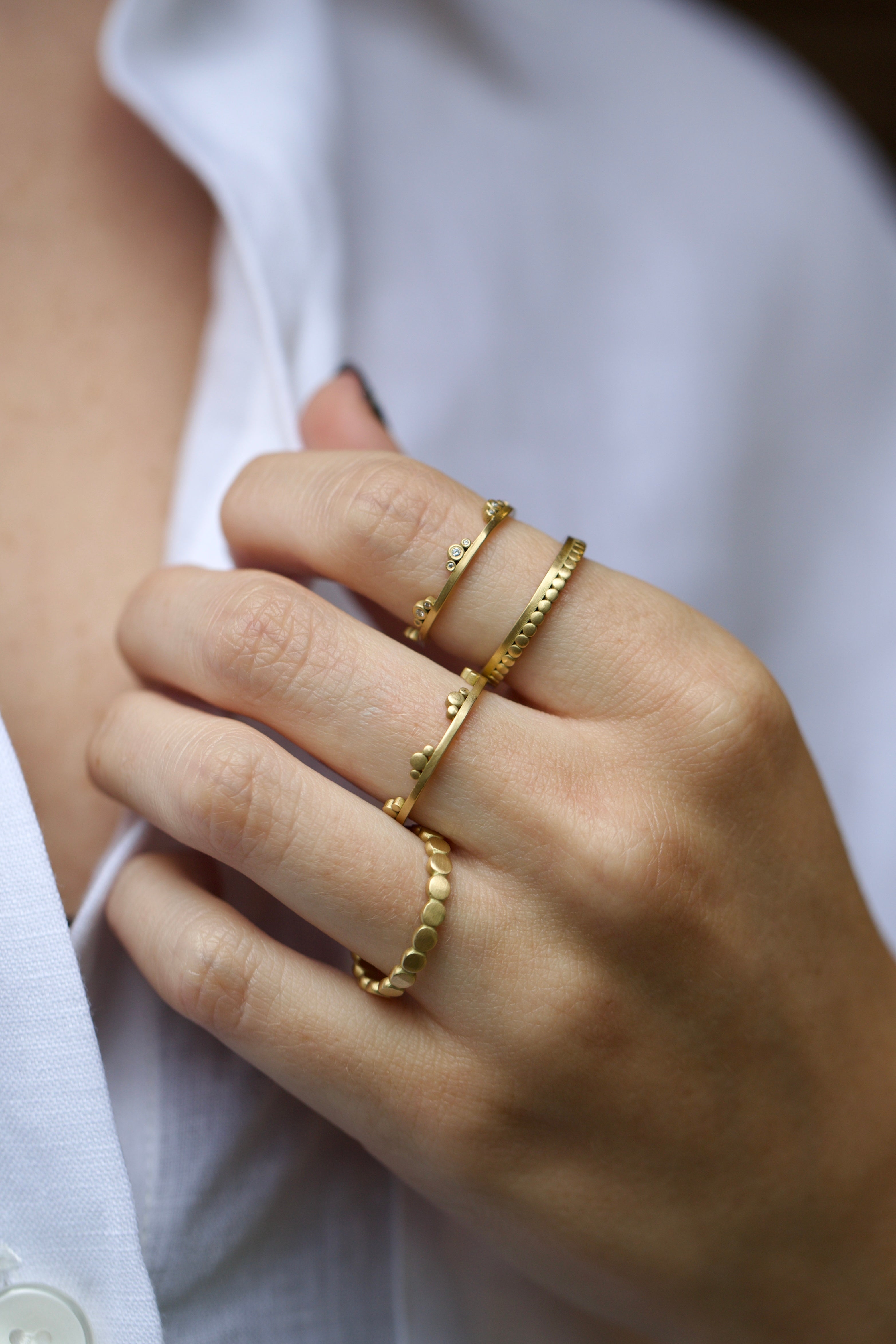 Image of American Jeweler Ananda Khalsa Diamond Side Trio 18k gold matte finish ring with seven 1mm white diamond trio encircling arrangement