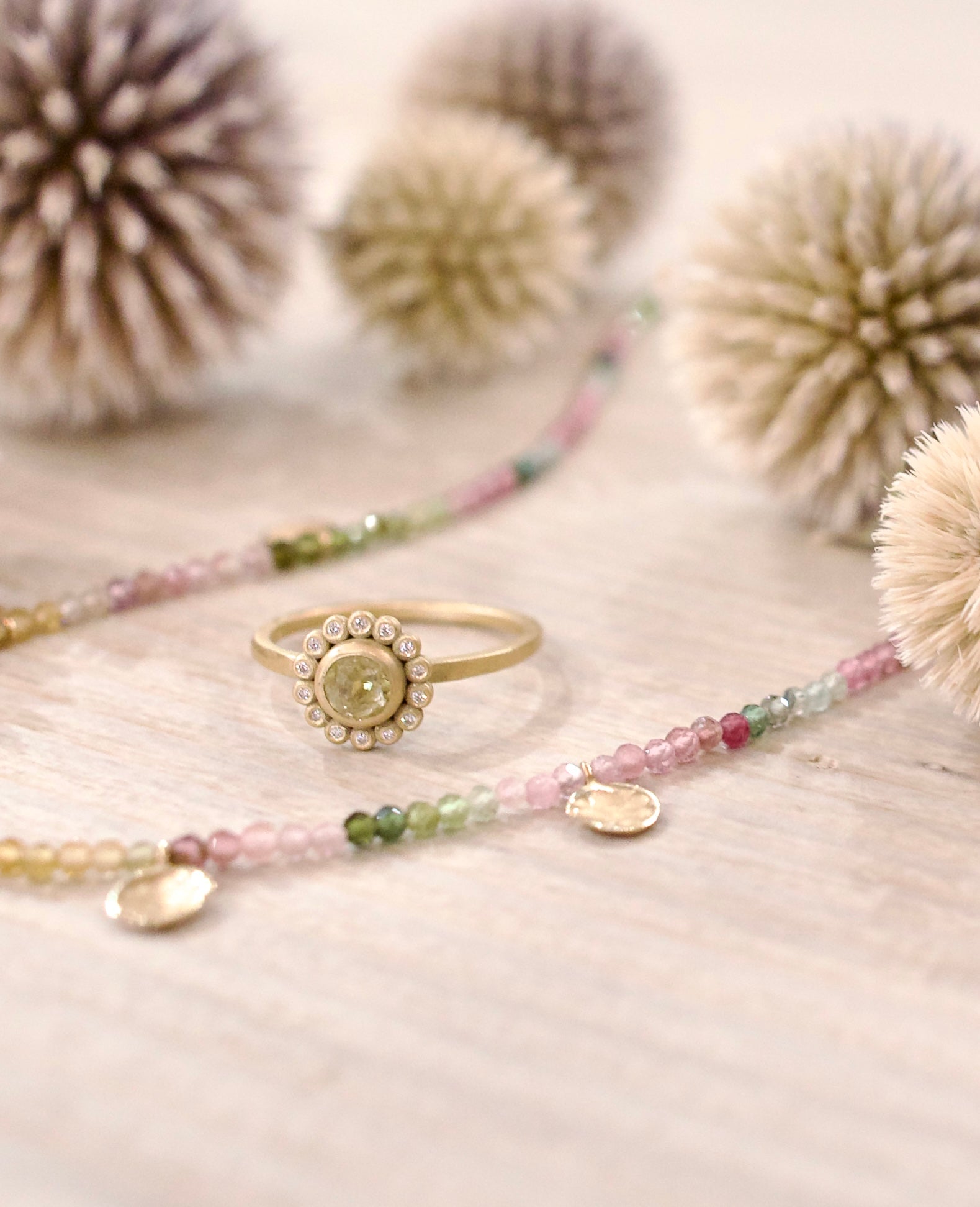 Image of Ananda Khalsa expertly handcrafted 18k matte gold ring with a center Rosecut Yellow Diamond and white diamond halo surround